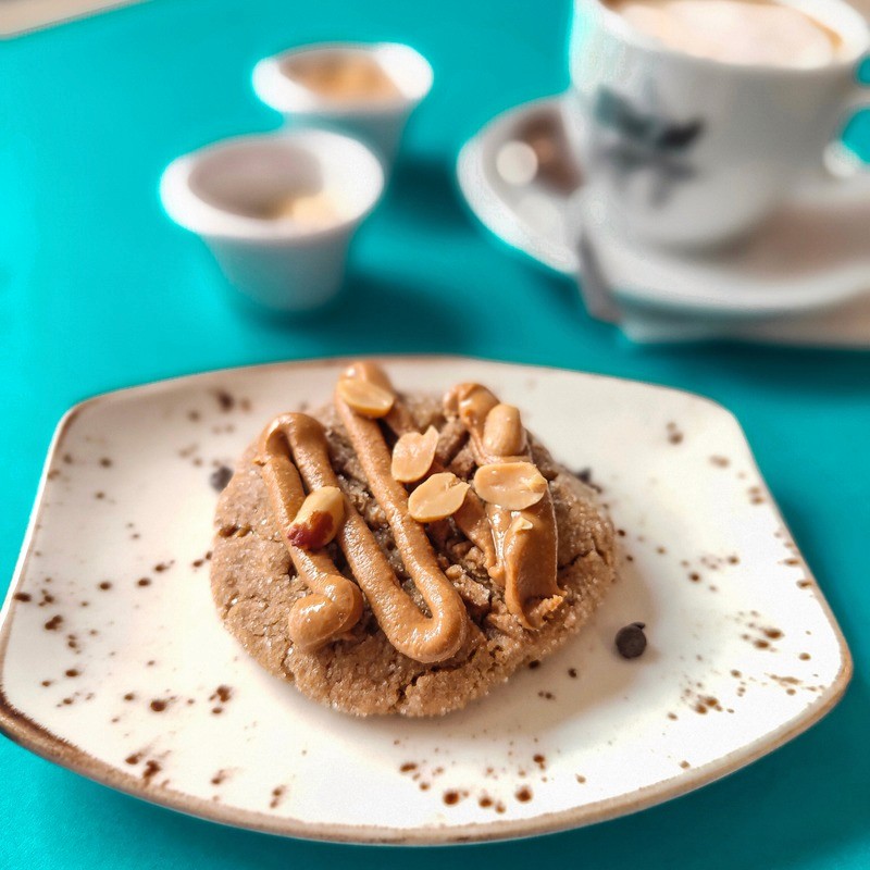 Peanut butter cookie with peanut butter icing and peanuts on top