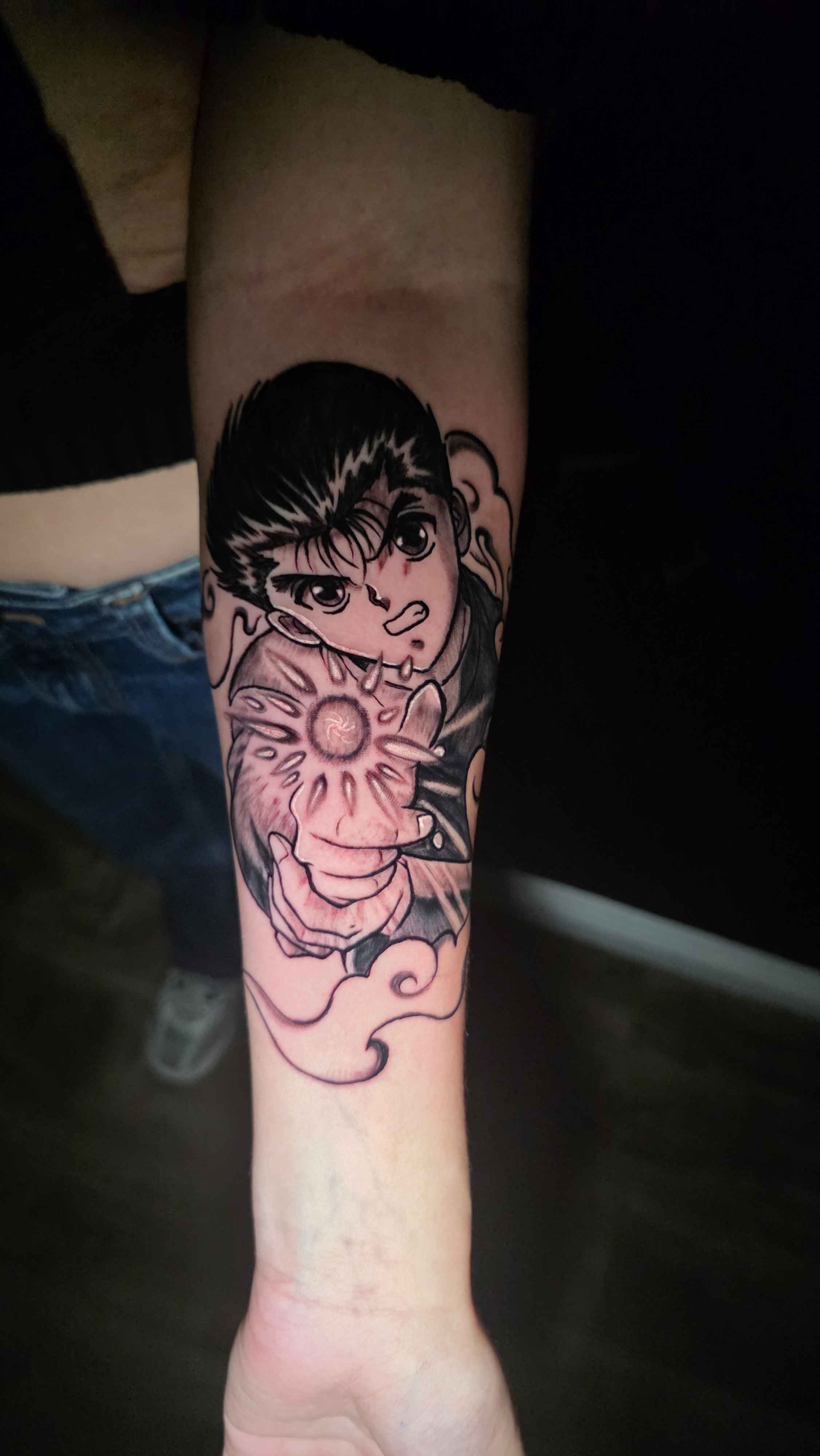 A forearm tattoo of Nezuko Kamado from Demon Slayer, depicted in a stylized anime art style. She is holding a sword.