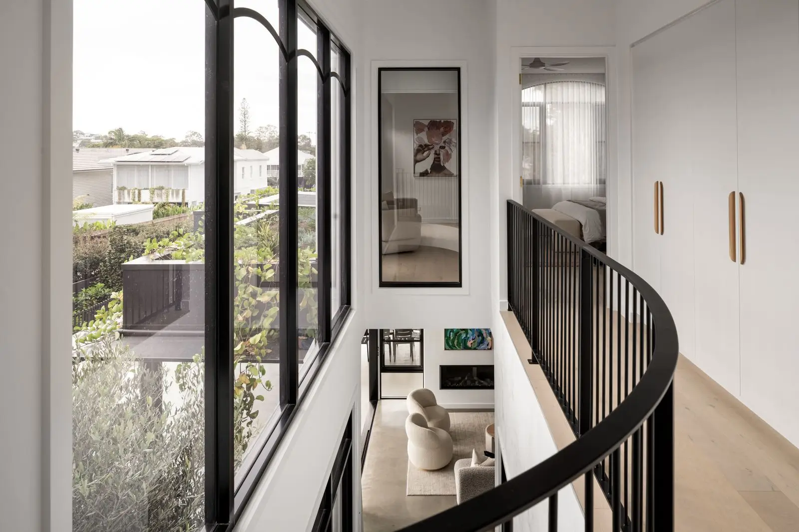 The void above the staircase where natural light floods the area through the windows