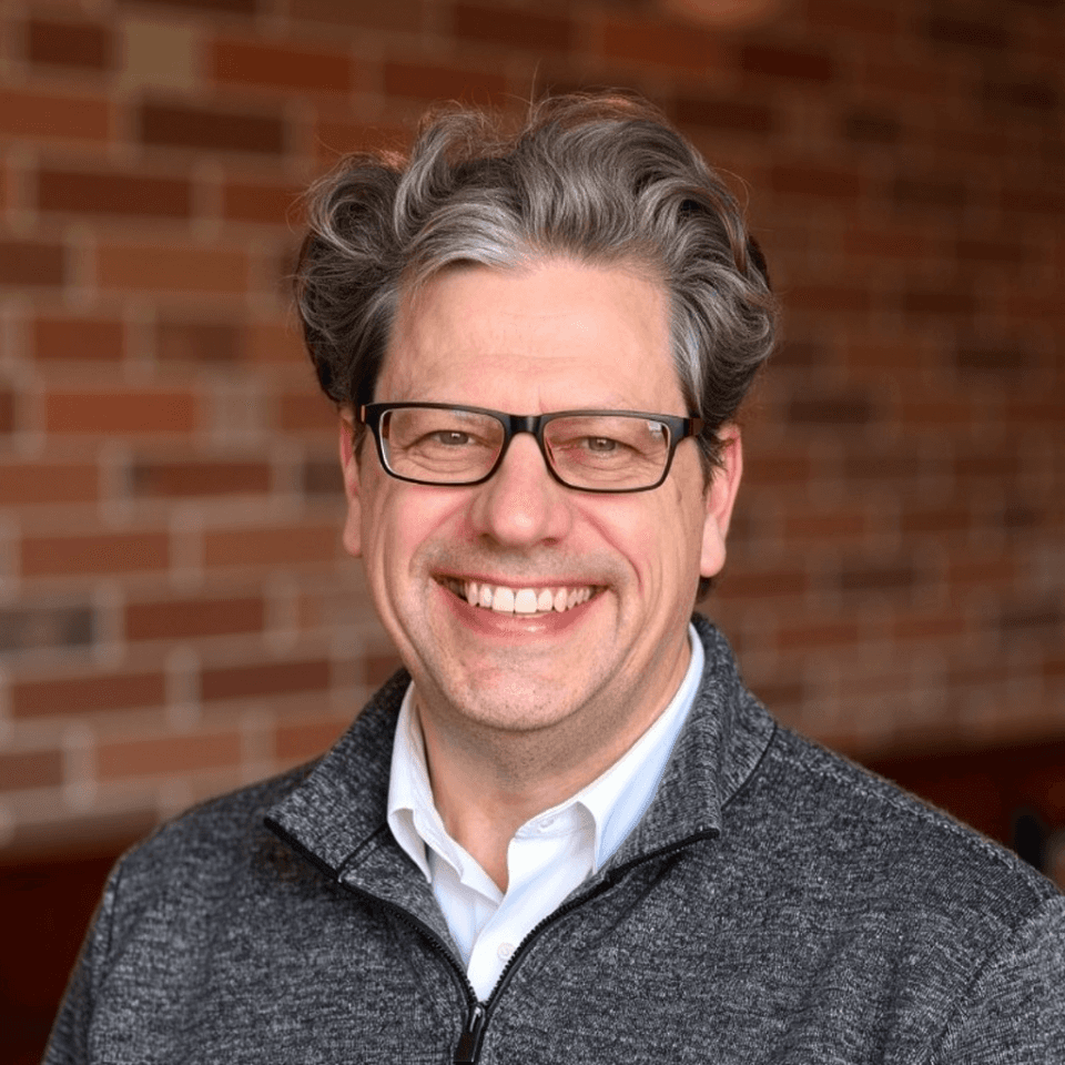 person sitting in a chair in front of a man