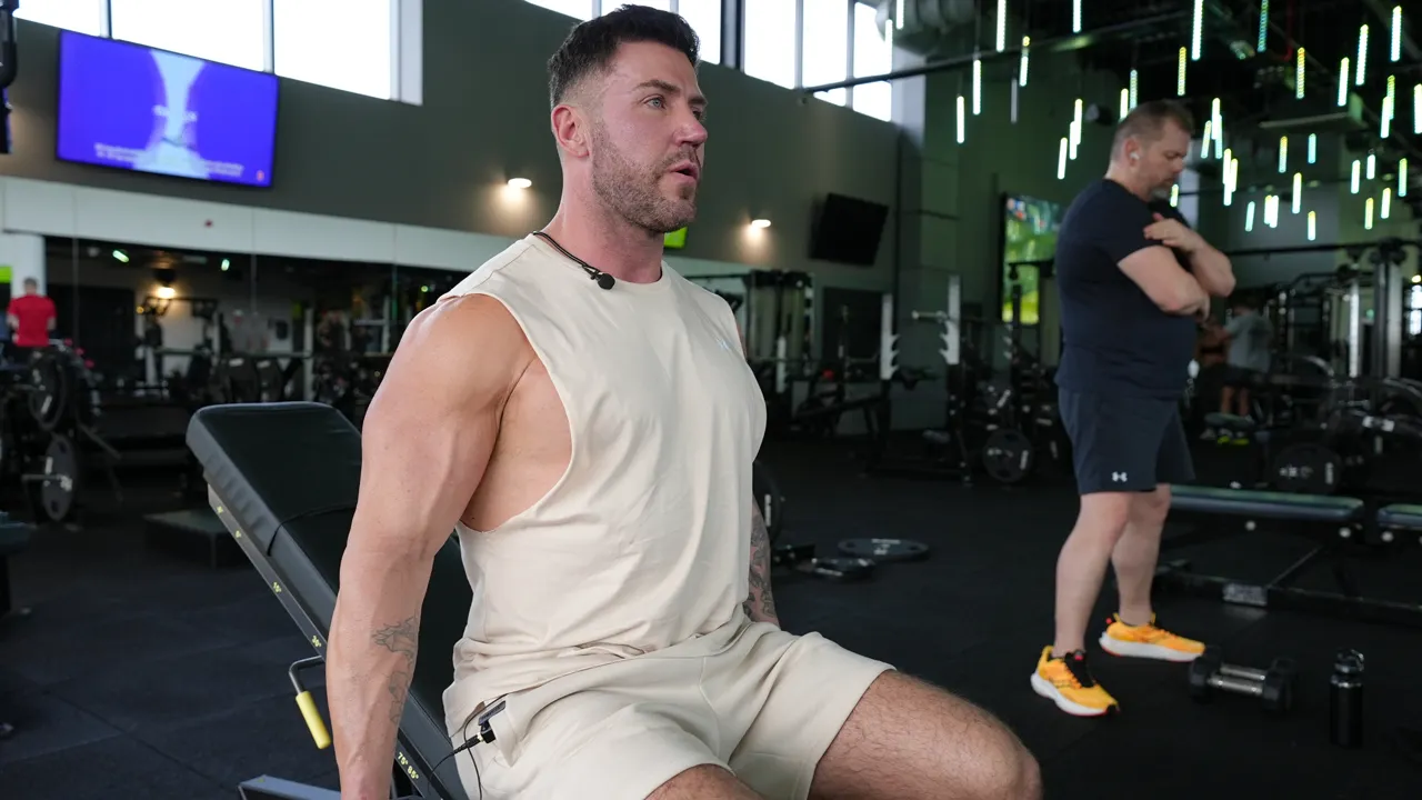 Danny Clifford performing a gym workout exercise during filming for a YouTube fitness video production project.