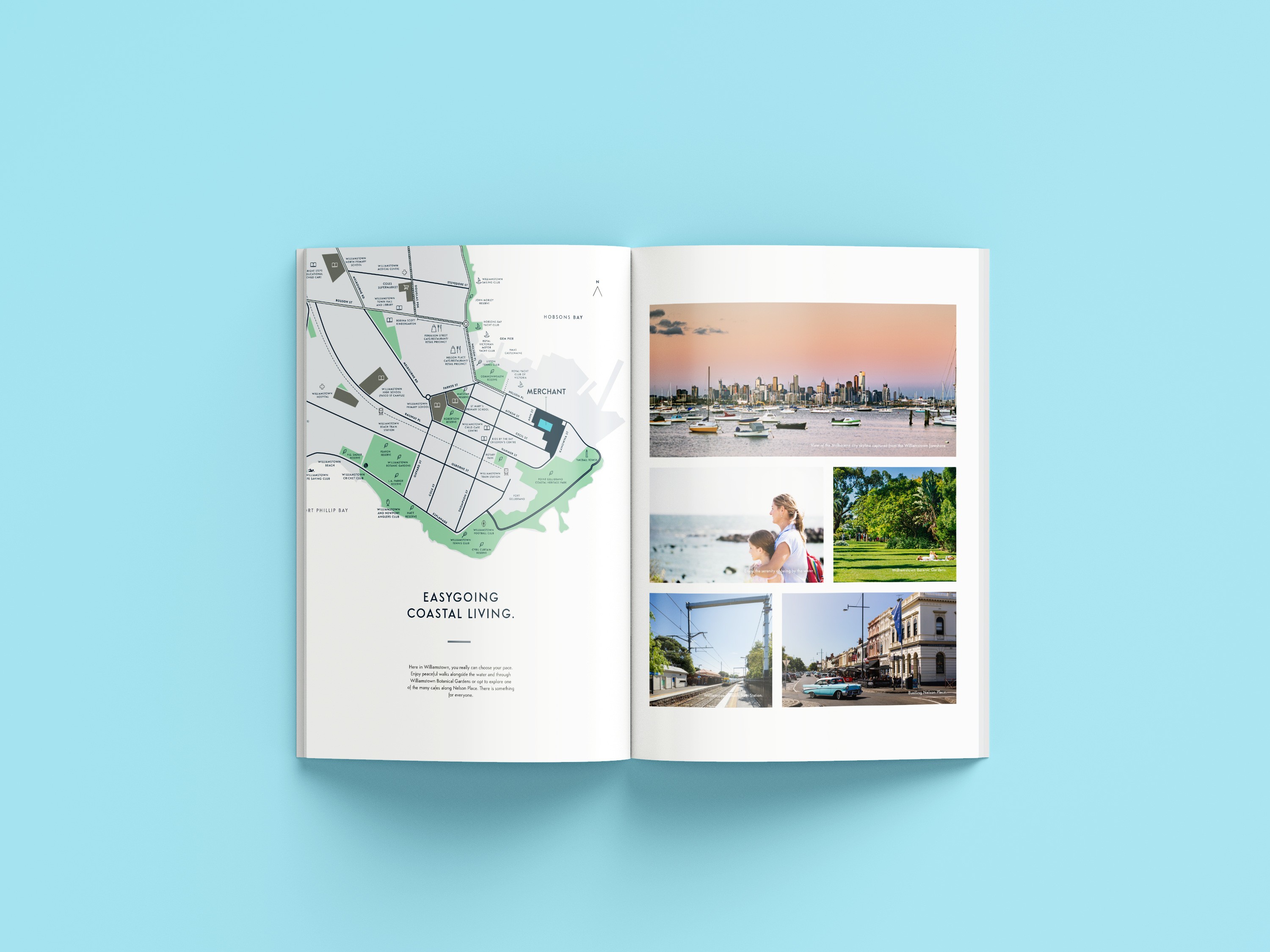 Open magazine on a blue background. Left page shows a map with "Easygoing Coastal Living." Right page has four images: a cityscape with boats, a parent with a child by the sea, lush greenery, and a street with historic buildings. Tone is relaxed and inviting.