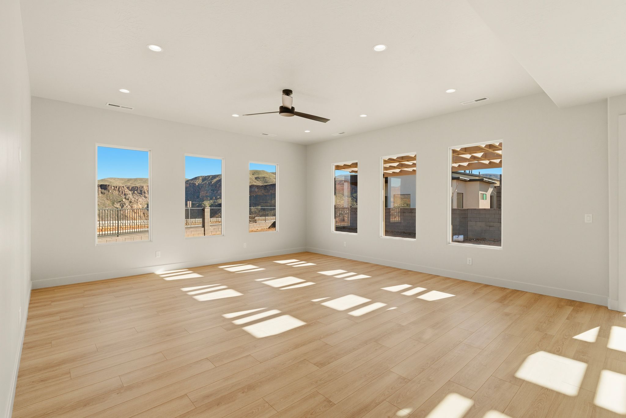 Living room at The View at Falcon Ridge in Hurricane, Utah, with open layout, vaulted ceilings, and large windows.