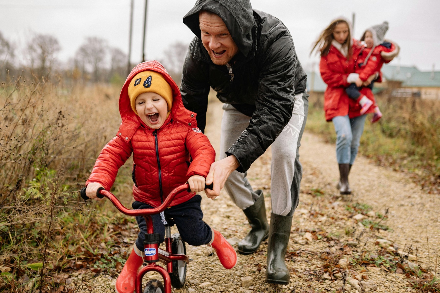 Child Riding Bike with Family