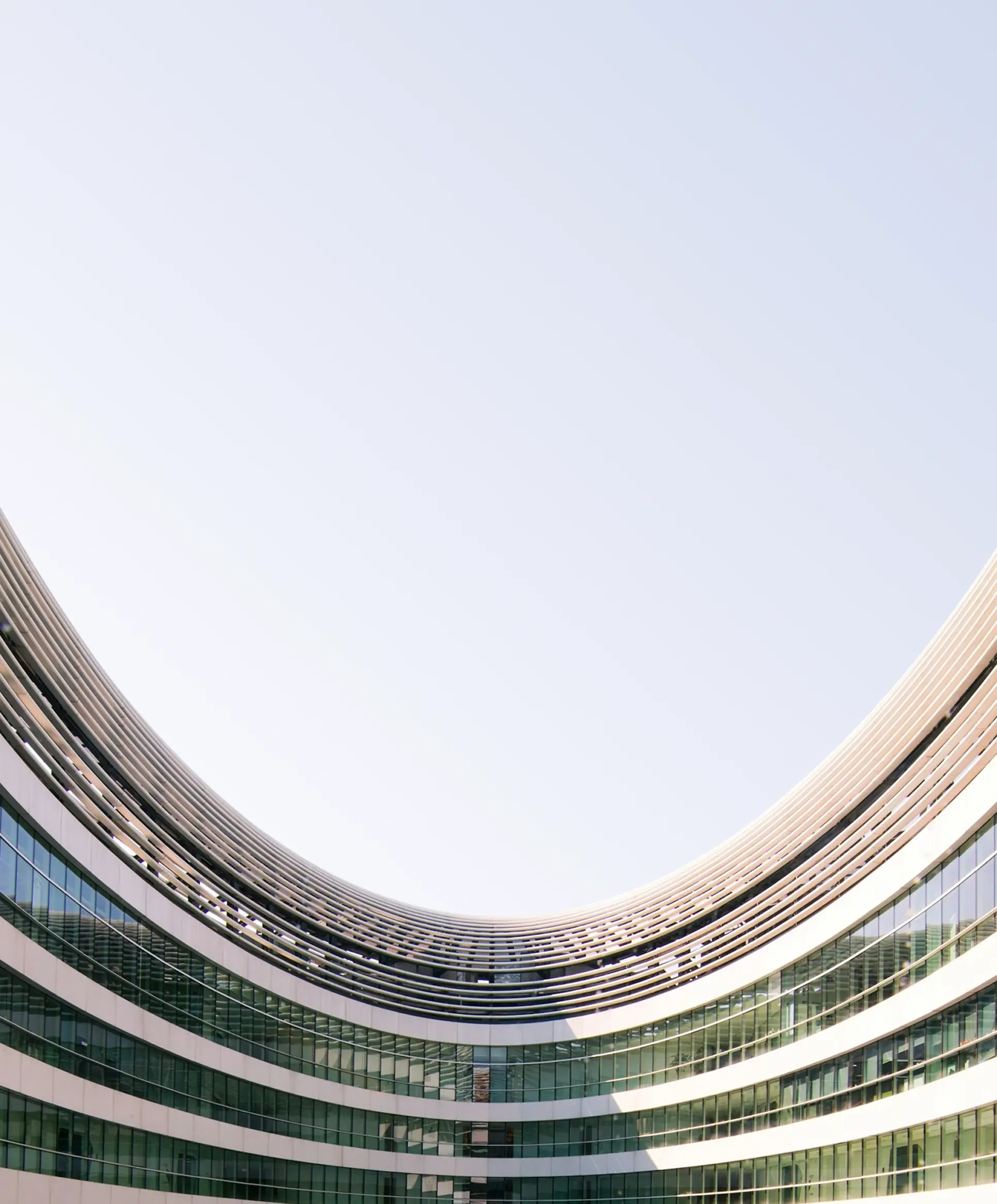 Curved building paned up to the sky