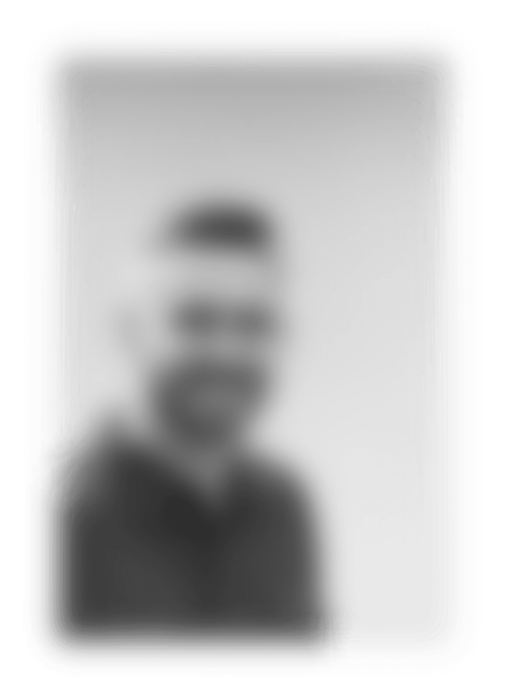 A man with a goatee smiles at the camera