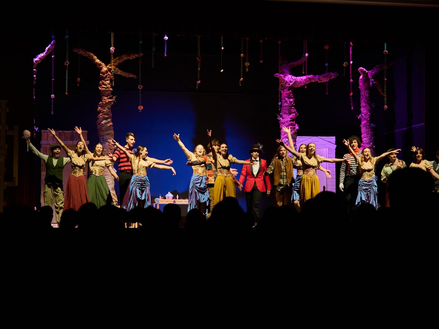 people standing on stage with lights turned on during nighttime