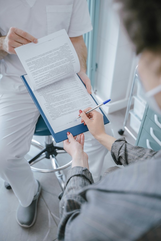 A patient signing a form.