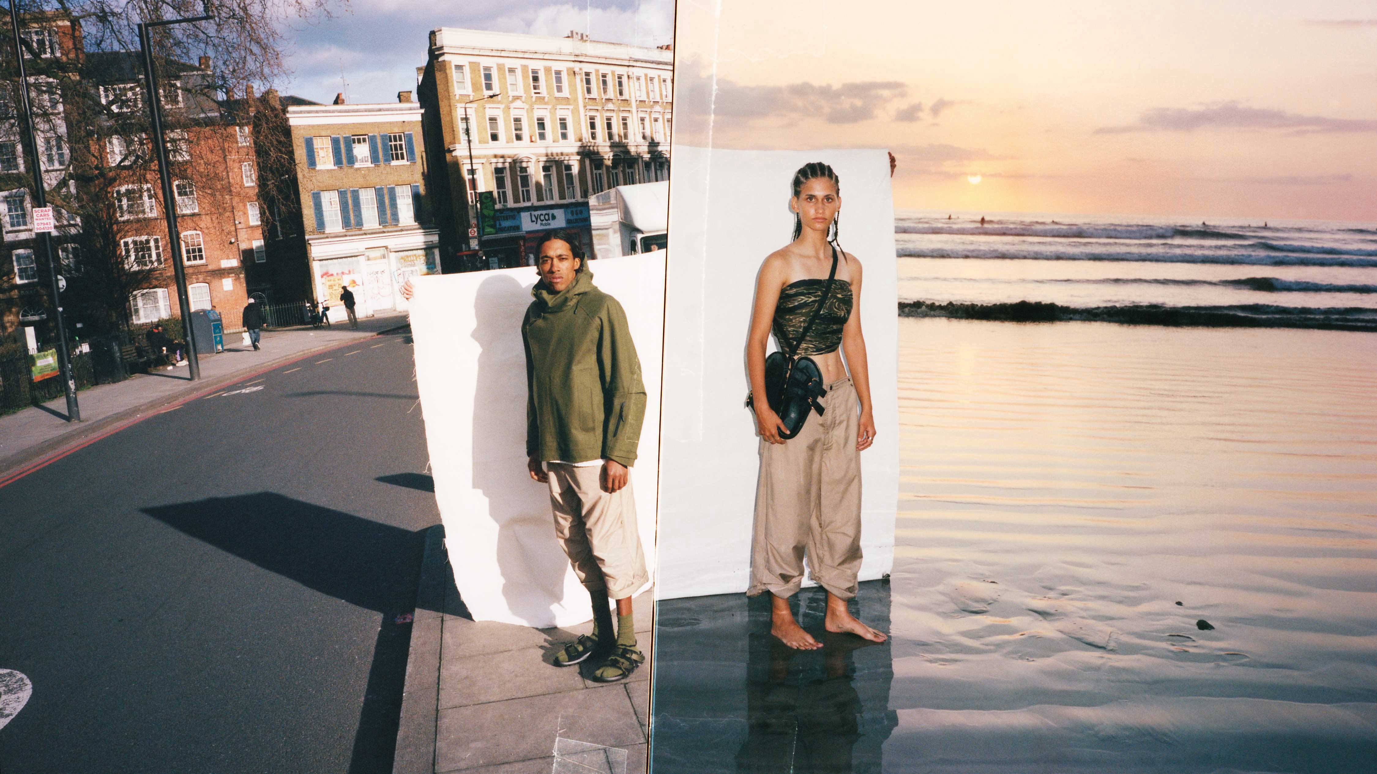 Two models stand at the water’s edge—one walking forward, the other reflected in a freestanding mirror in the wet sand—evoking Birkenstock 1774’s reimagined approach to beachwear and reflective craftsmanship.