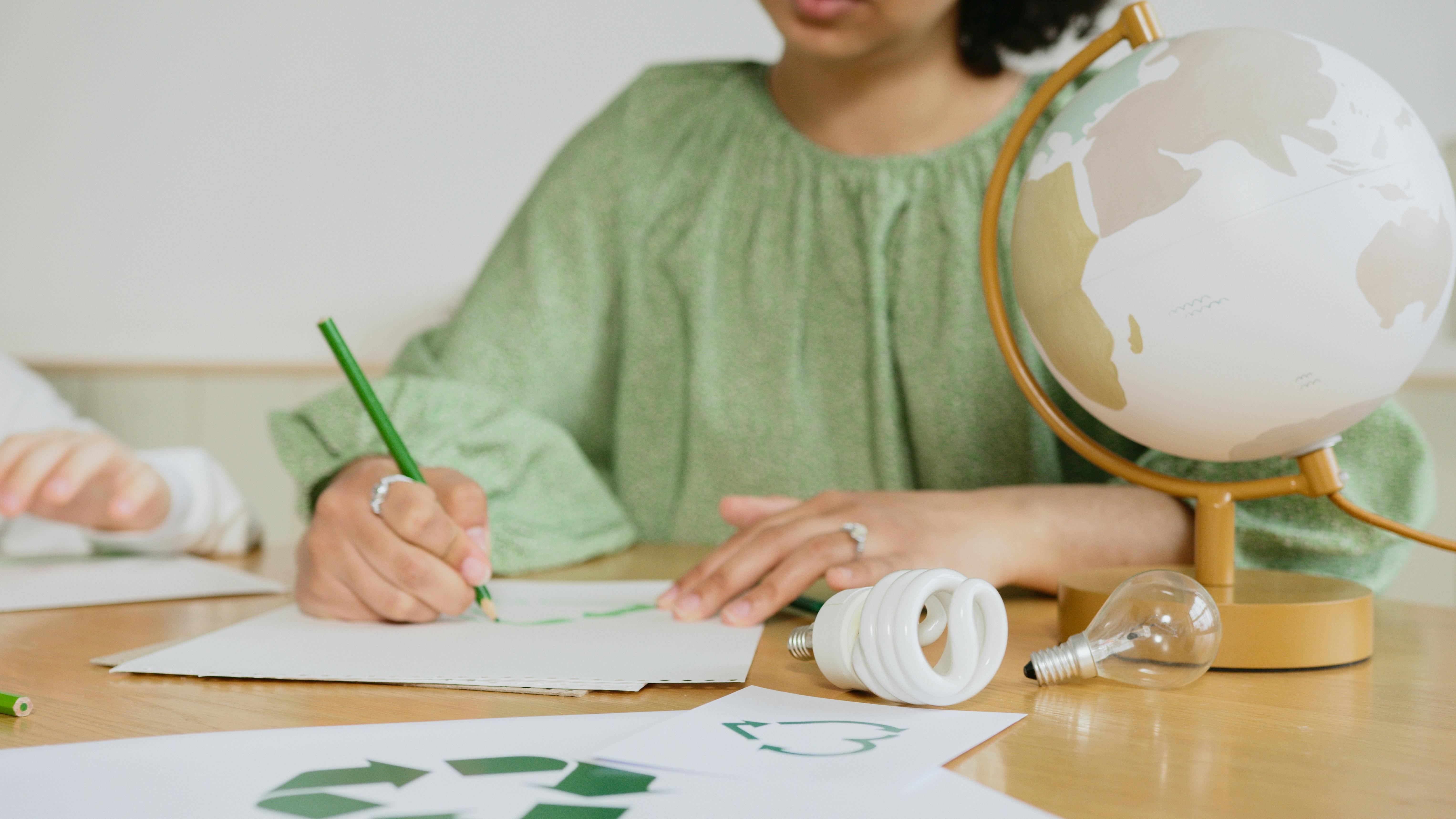 A teacher drafting a plan on paper