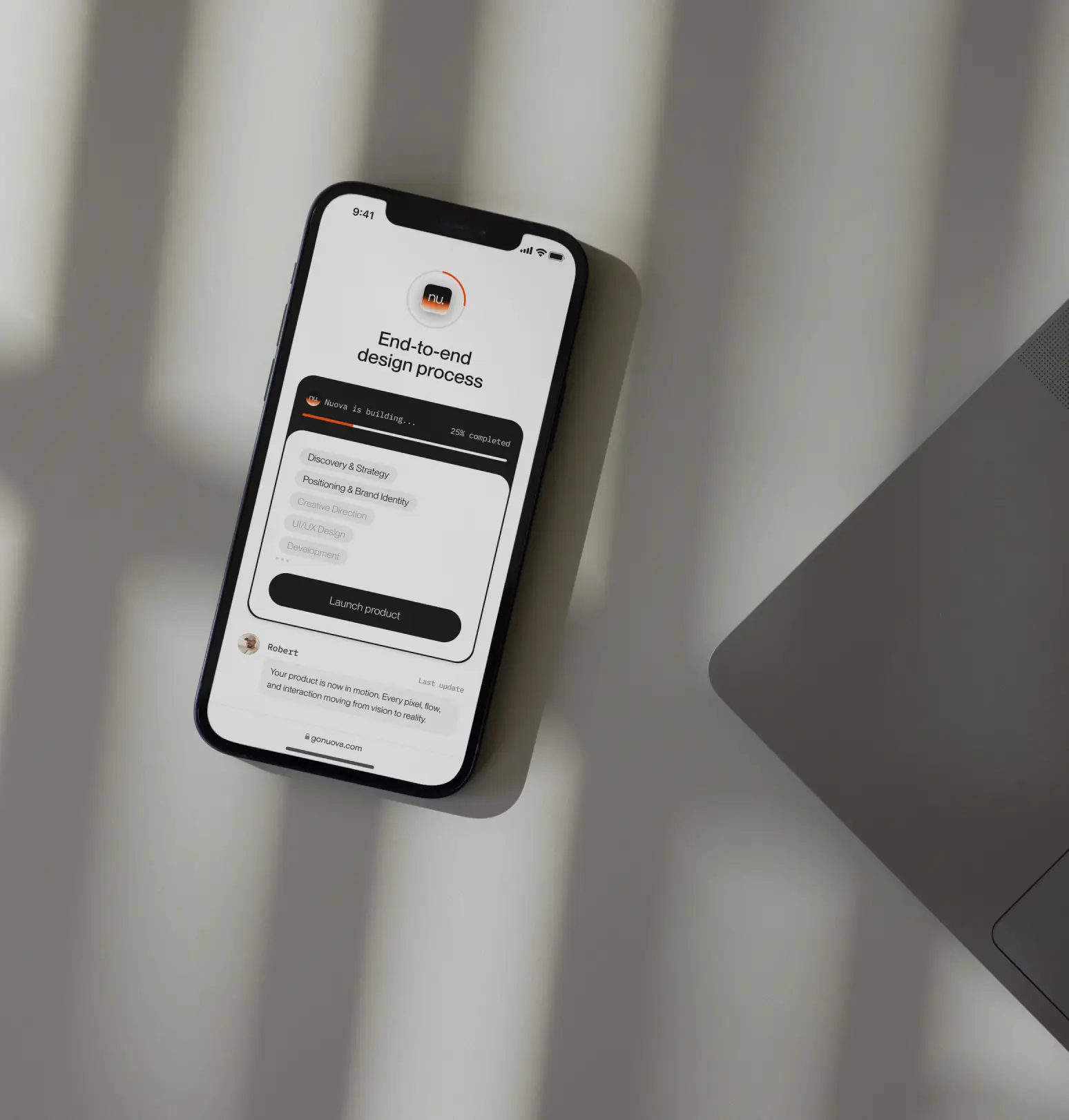 A phone standing on a table and showing a website interface