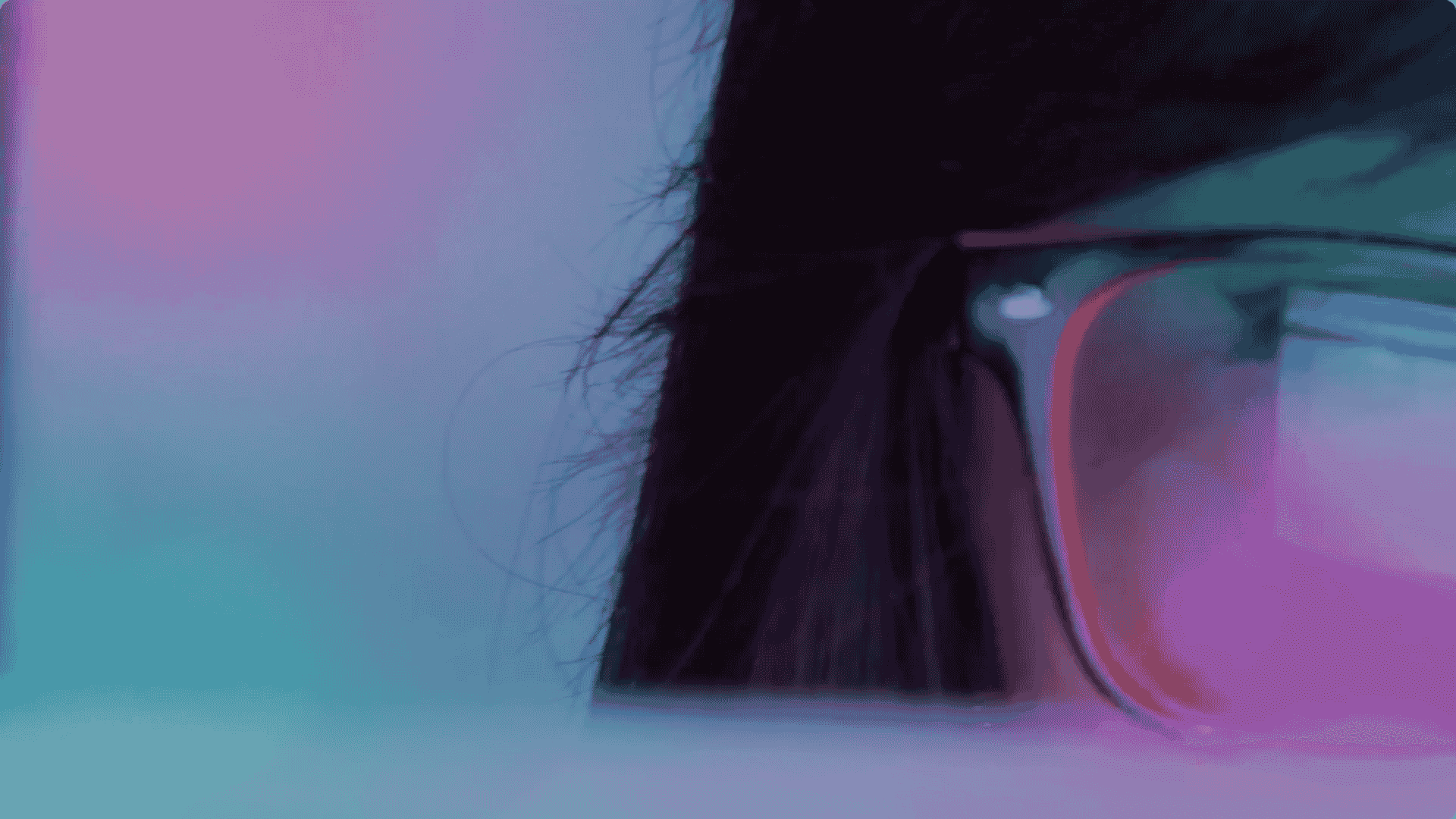 A close up of half a woman's face with glasses reflecting a computer screen