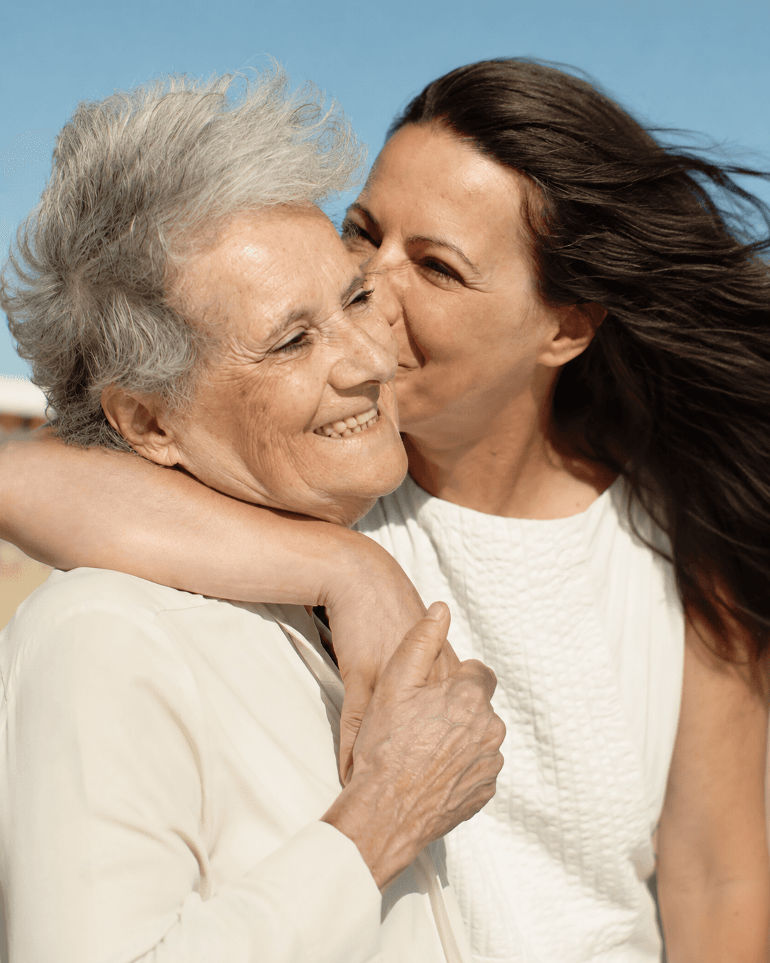 Adult daughter embracing her elderly mother