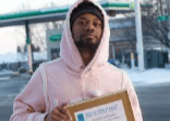 Damon Kirk outdoors holding a document.