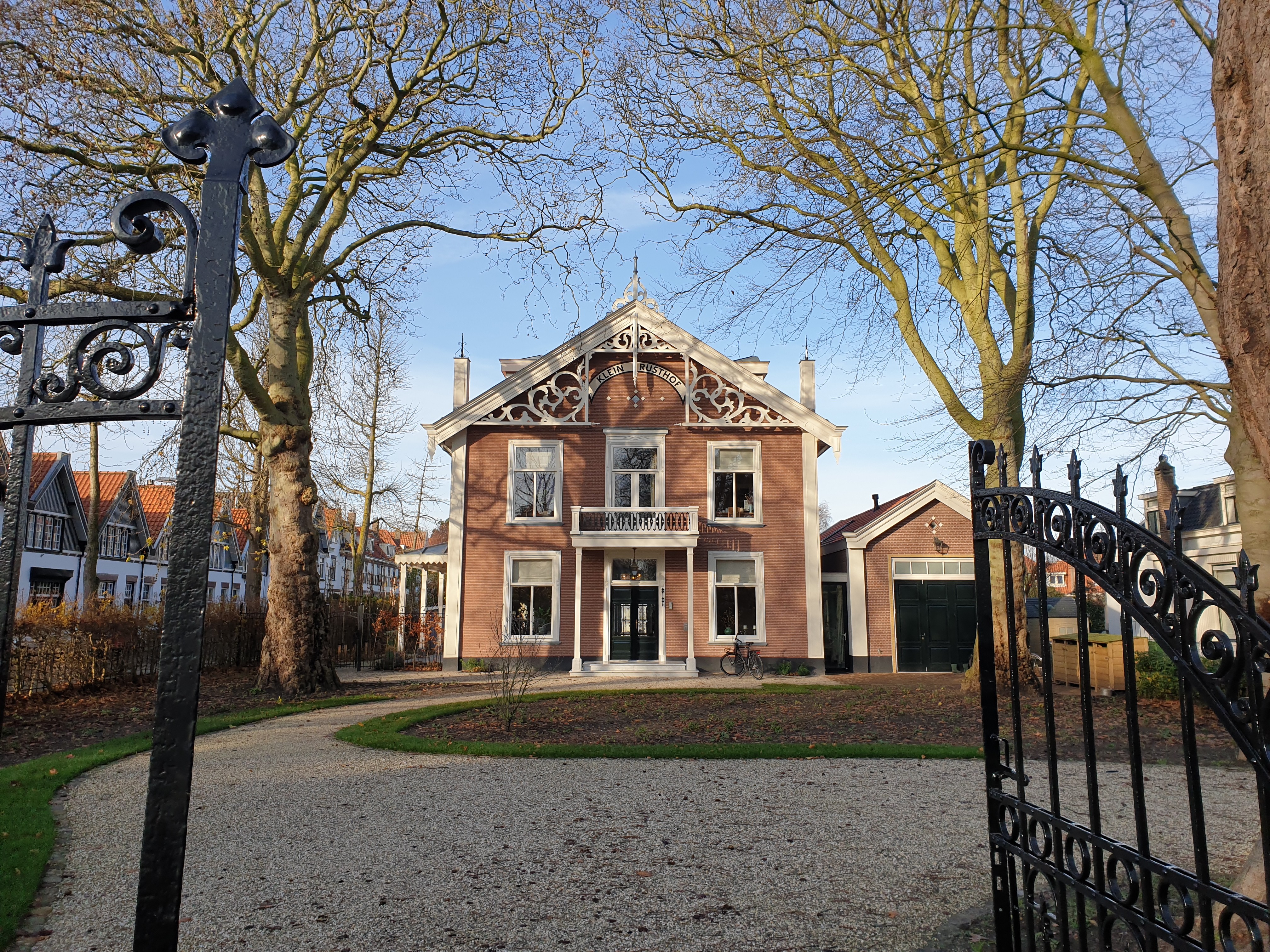 Path leads to tropical huts and lush greenery.