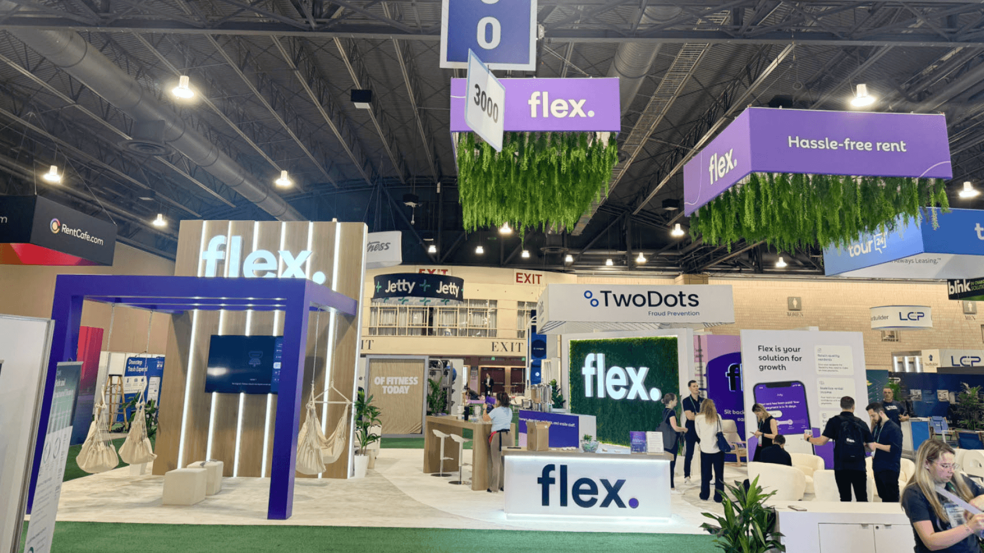 30x40 booth planning at Las Vegas Convention Center with large island layout, demo zones, branded graphics, meeting counters, and wide aisle visibility