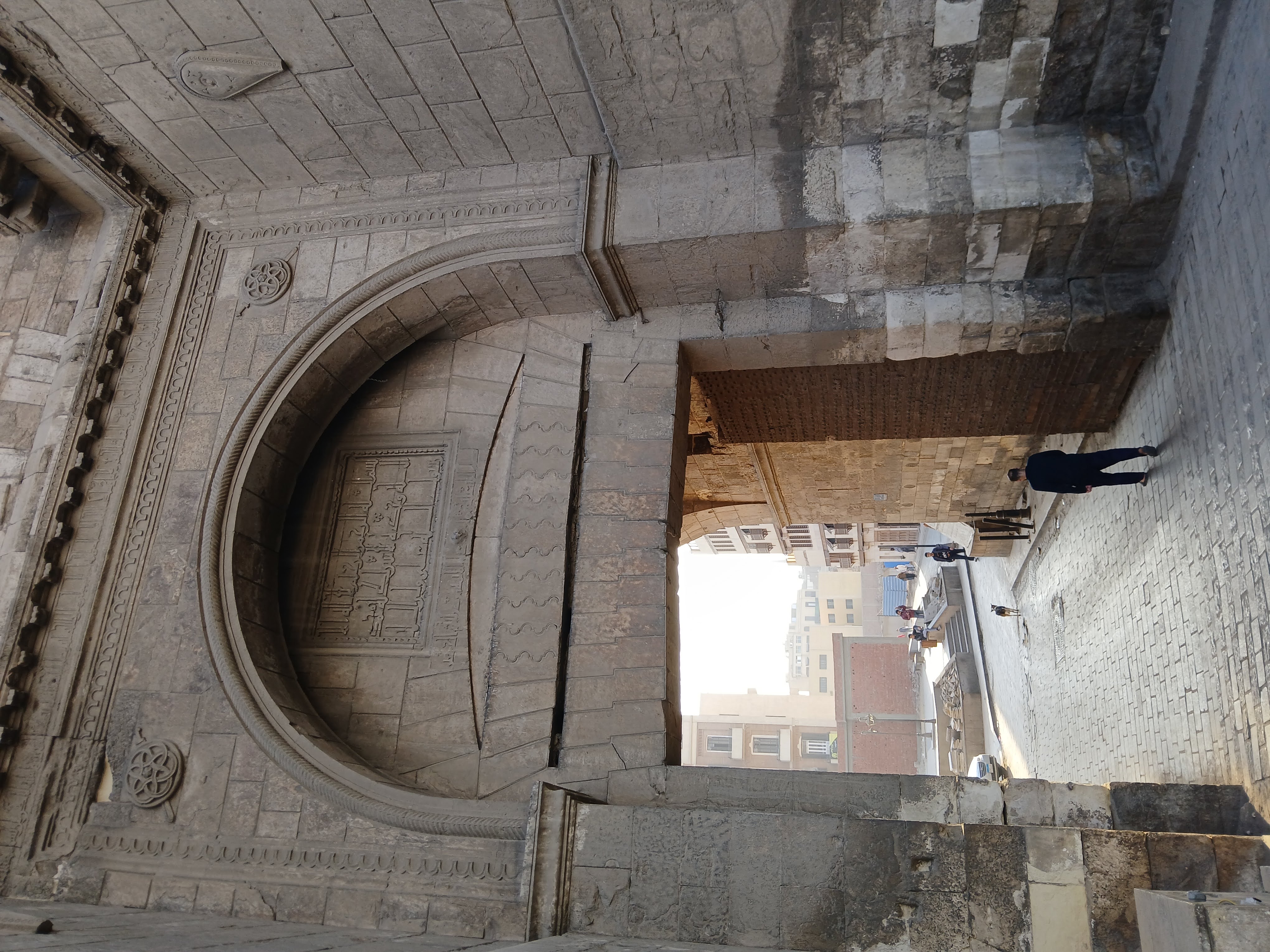 A Gate from Fatimi Cairo, a large doorway leading inside the city with text written over it in arabic in Kufic script