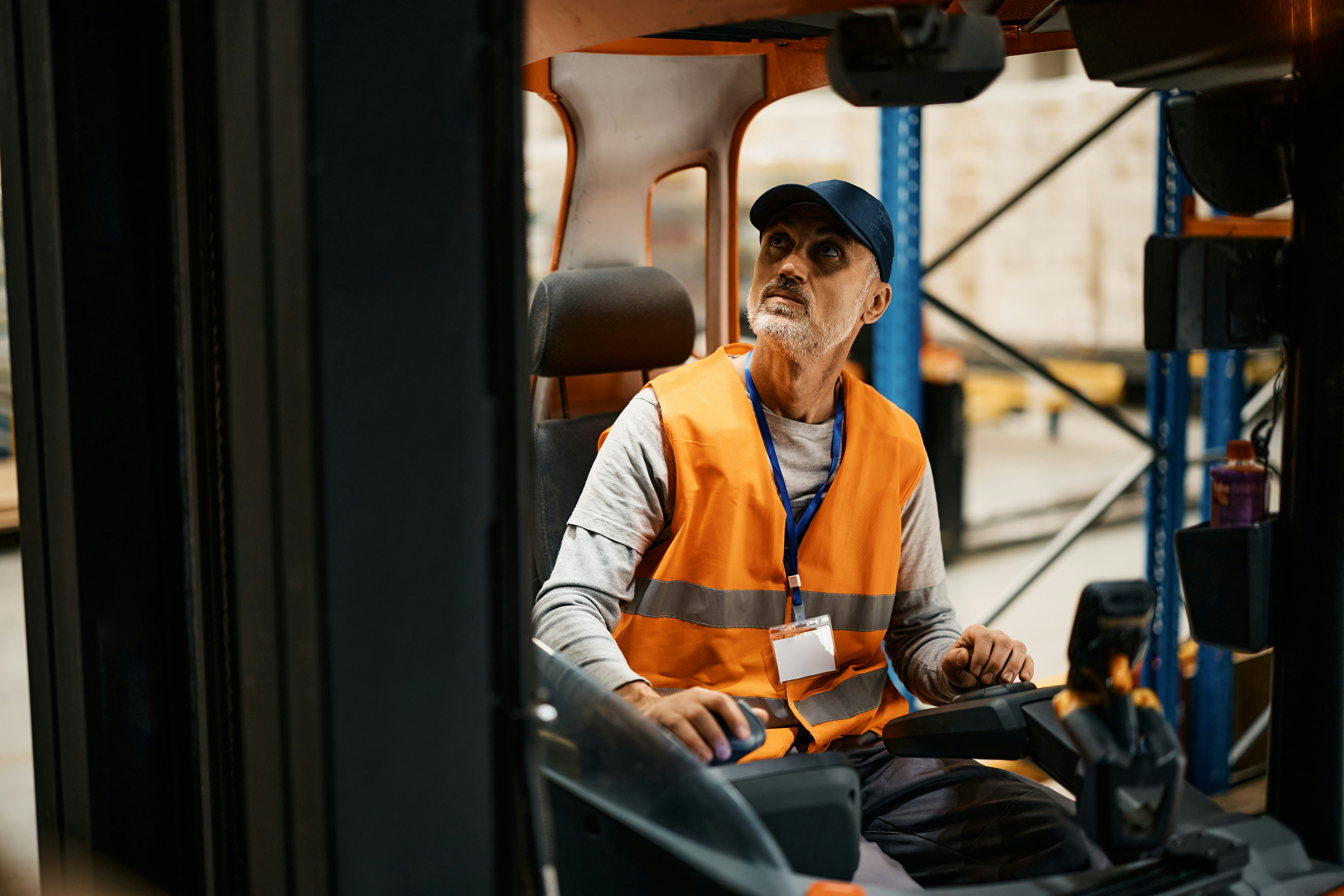 man in high-vis jacket driving a forklift truck