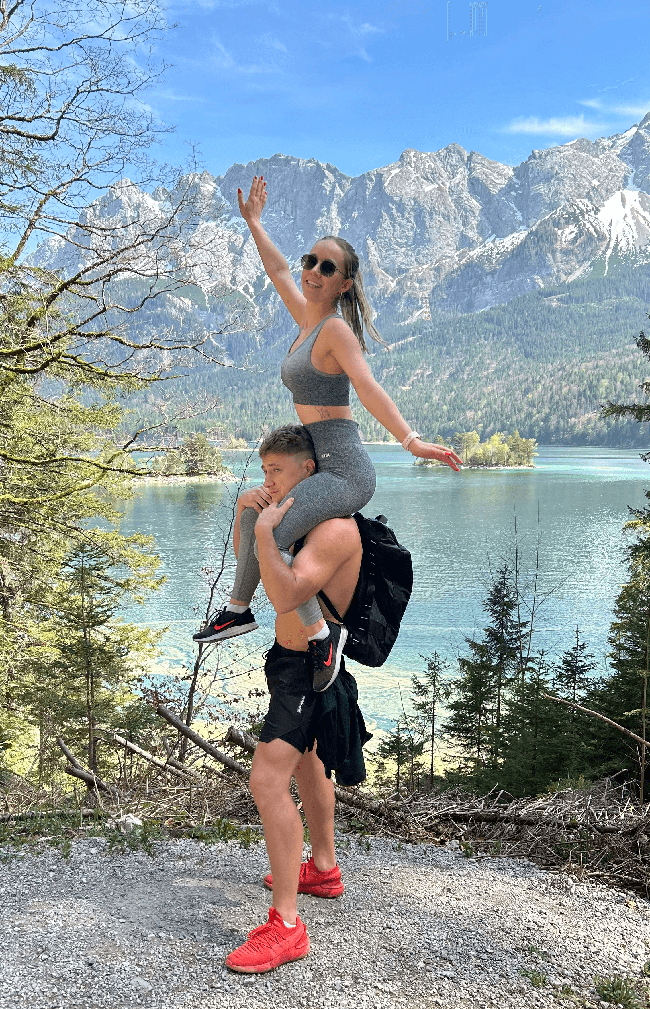 A close-up of two people holding hands, one wearing a denim jacket. The background is softly blurred, suggesting a tender, intimate moment in warm light.