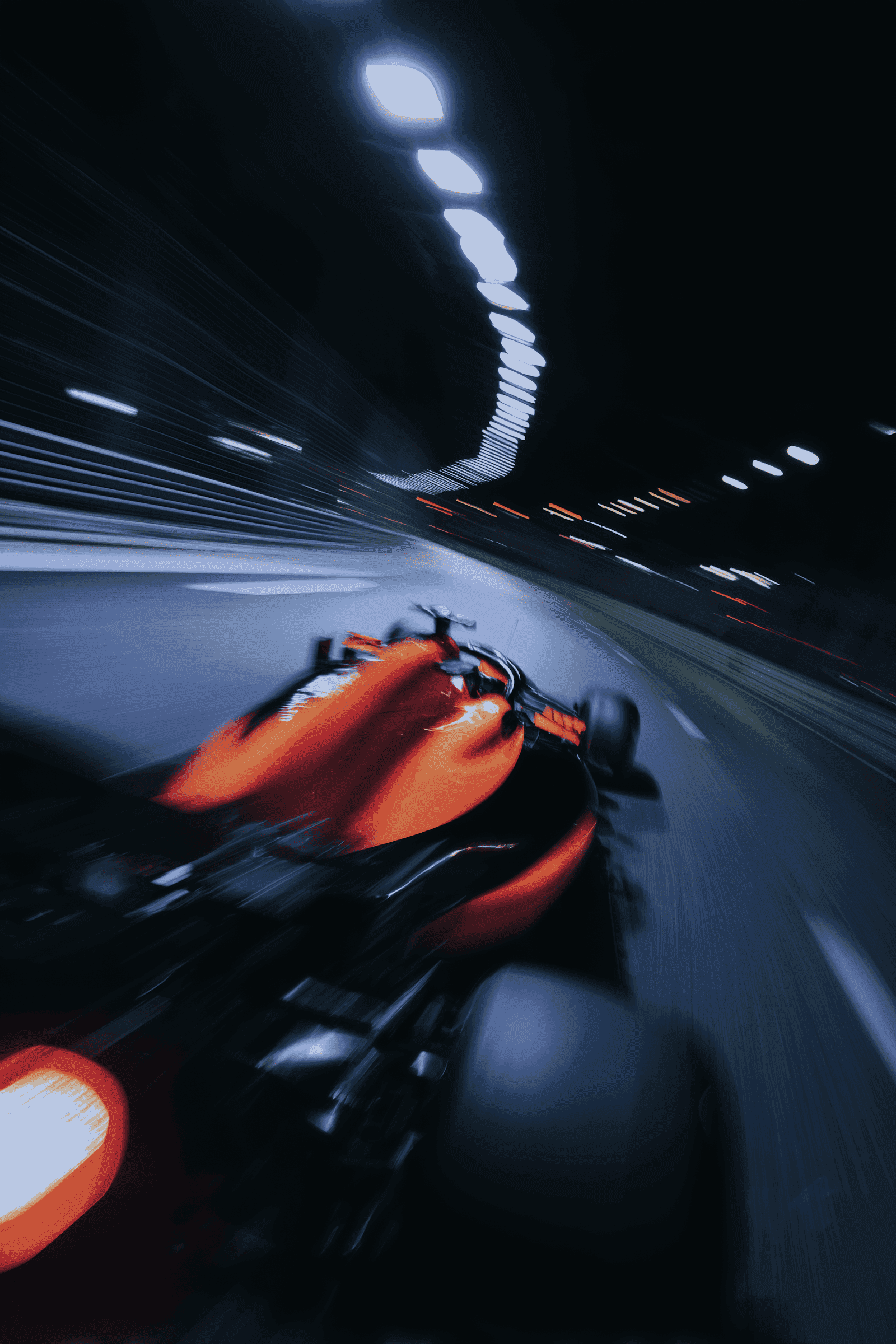 Formula 1 race car speeding through a tunnel at night with heavy motion blur