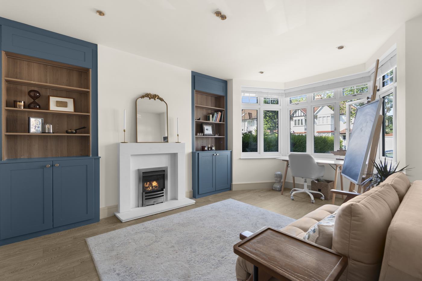 Front reception room with bay window, fireplace and blue built-in shelving, High Barnet