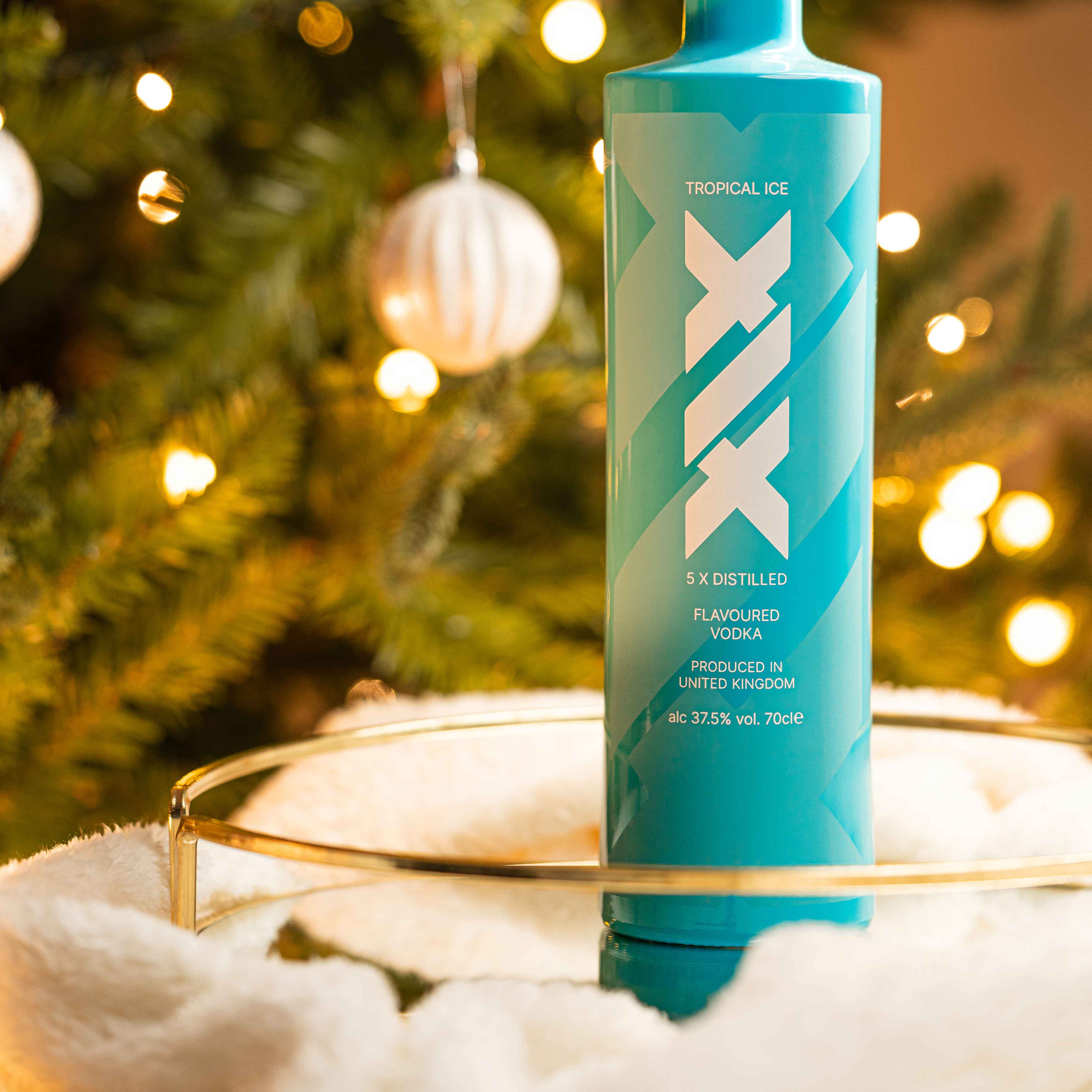 man standing on rocks wearing a winter jacket and a pair of trackpants