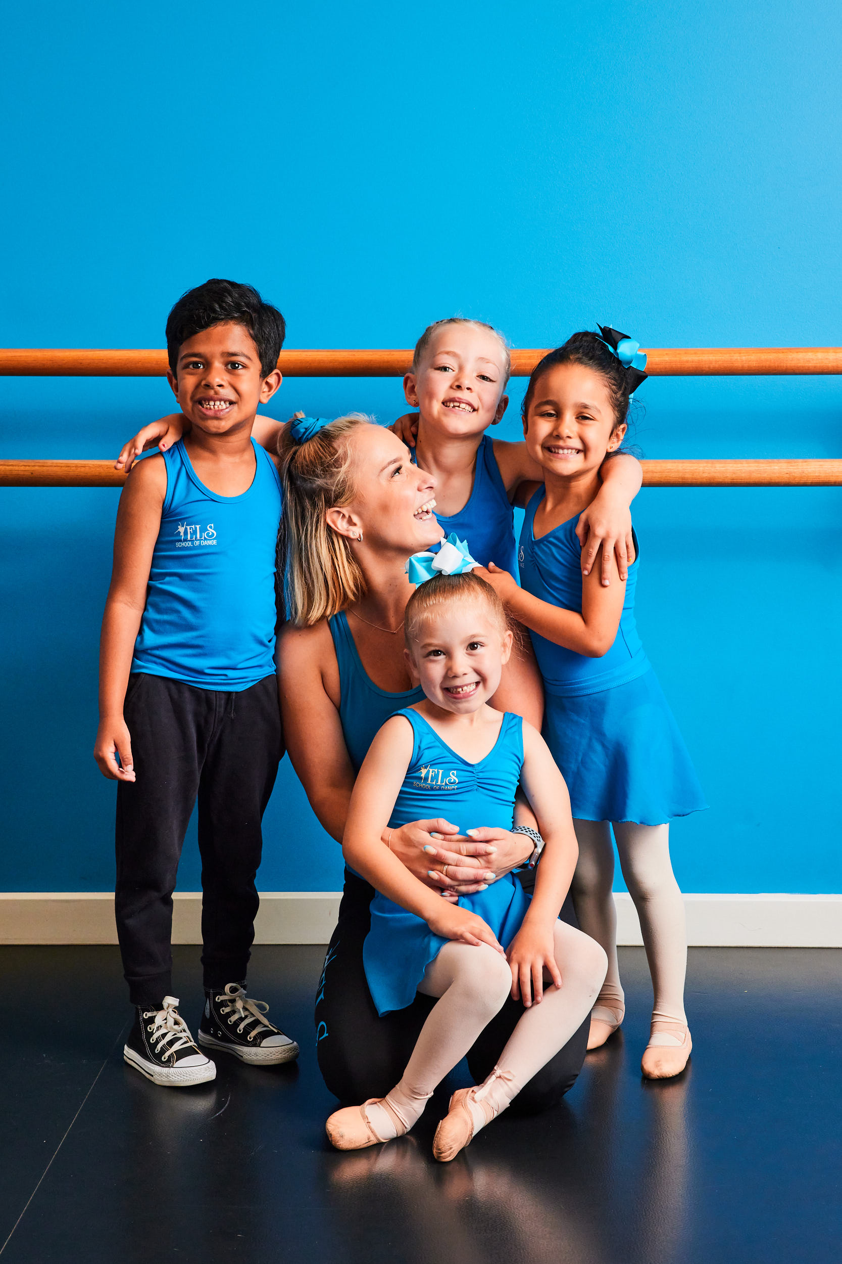 dancers hugging teacher
