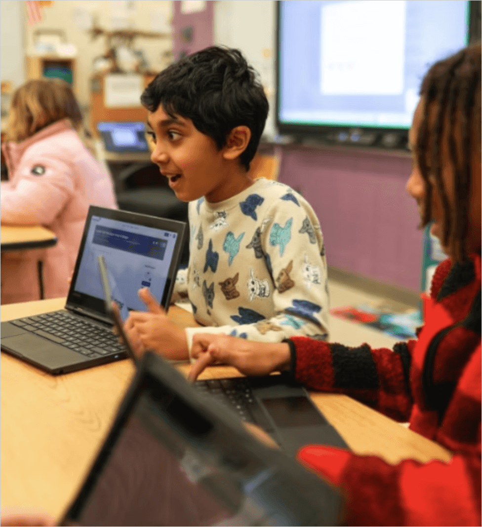 Student holding a computer at Apison Elementary School.