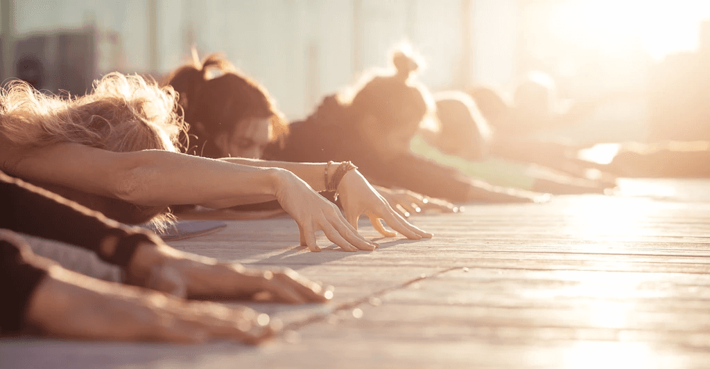 Two people stretching on yoga mats