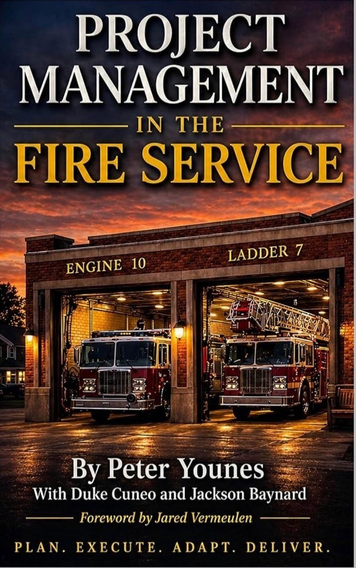 Book cover for “Project Management in the Fire Service” featuring fire engines inside a station at sunset.