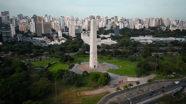 A person stands in a sandstone cave.