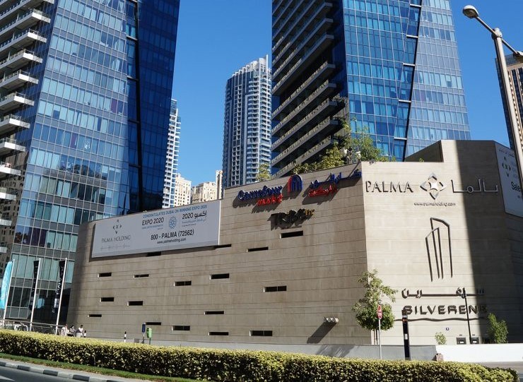 Exterior of Silverene Tower showing the podium retail level and residential glass towers.