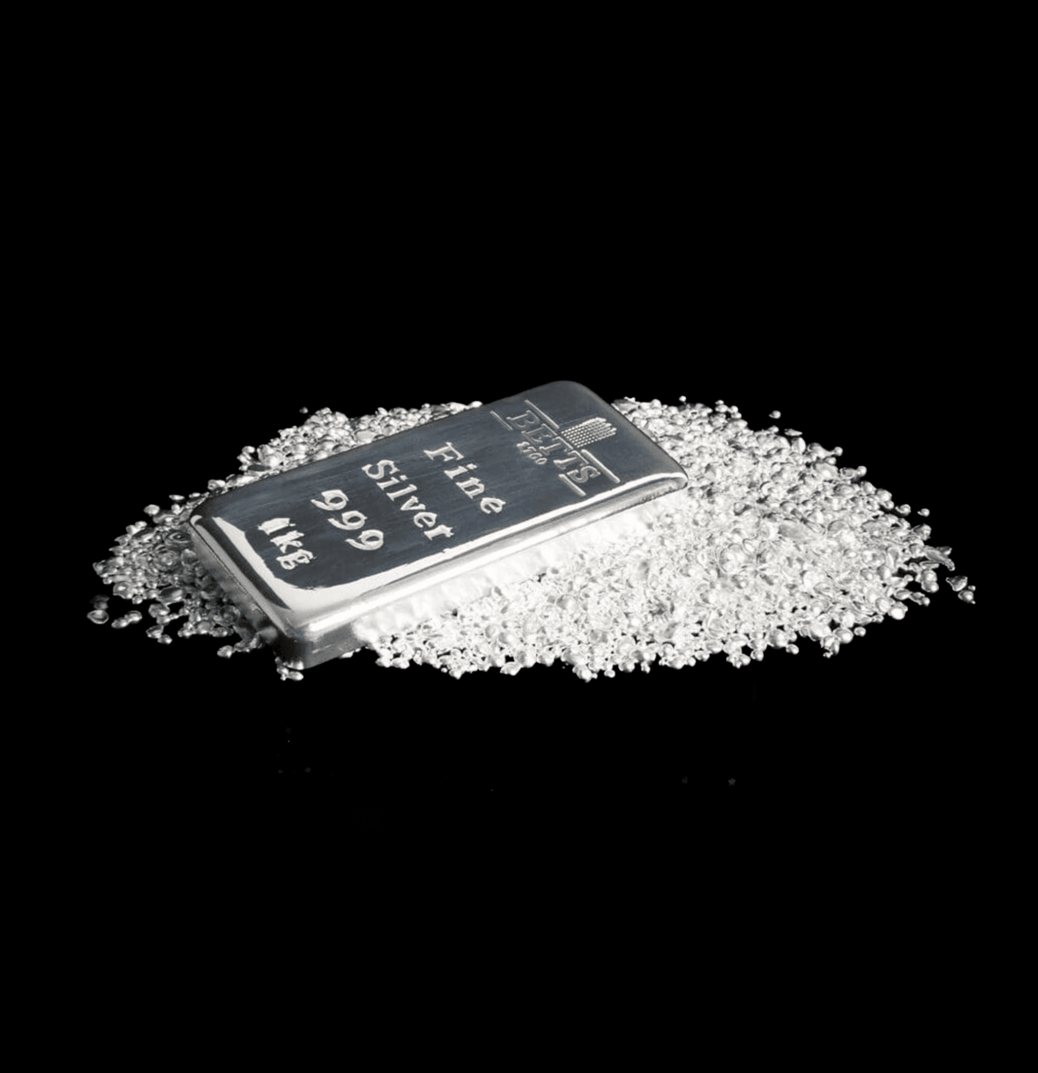 A high-contrast shot of a polished 1kg fine silver ingot engraved with "Betts 1760 Fine Silver 999," surrounded by scattered silver casting granules on a dark surface.