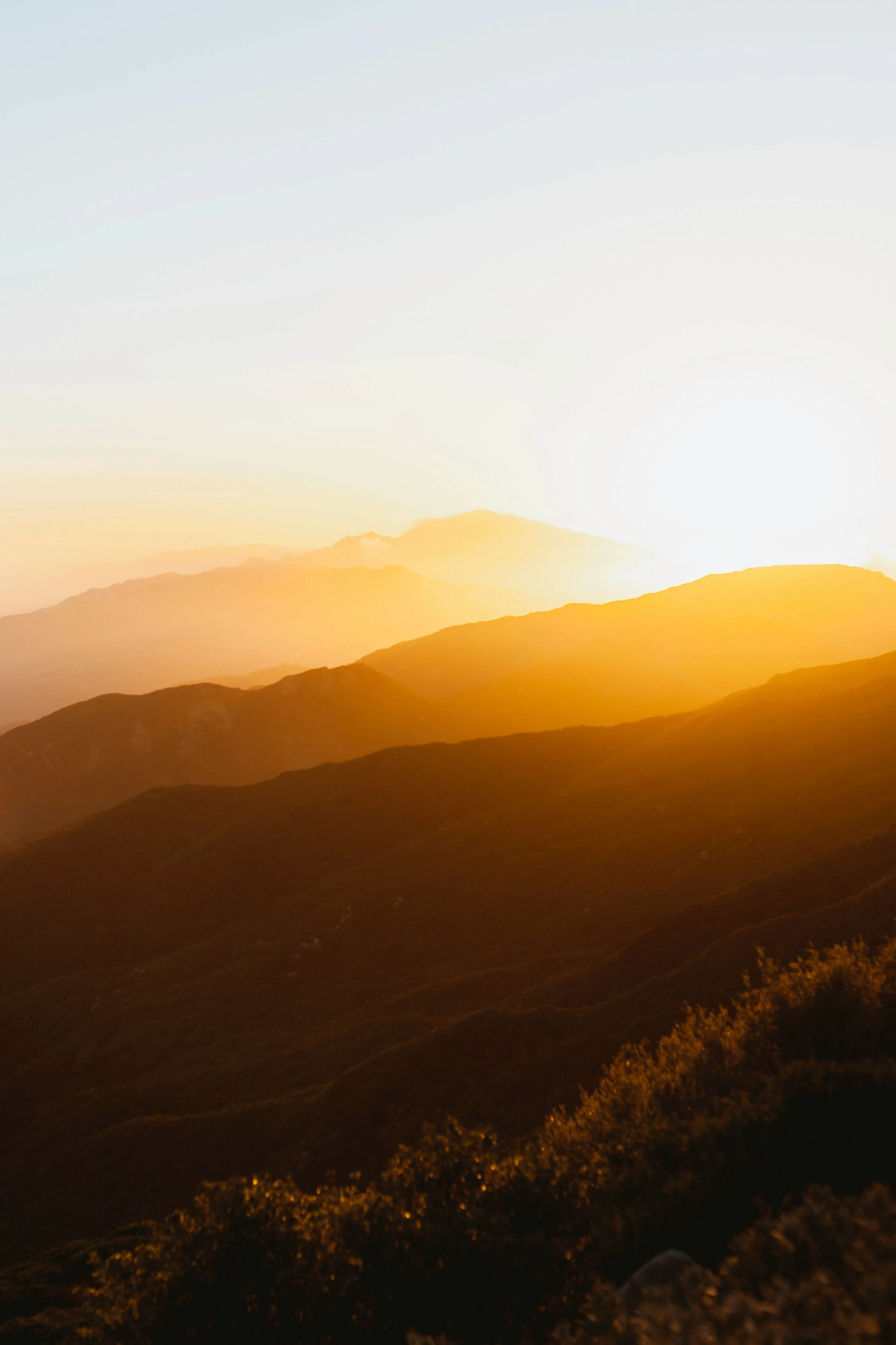 A glowing golden sunset stretches across layered mountain ranges, symbolizing the expansive and transformative journey of spiritually queer relationship therapy. The warm light cascading over the hills reflects themes of healing, emotional depth, and conscious love beyond heteronormative expectations. Just as the mountains unfold in soft gradients, queer relationships invite partners to move beyond rigid right-and-wrong narratives and explore deeper spiritual growth, vulnerability, and authentic connection. This serene landscape mirrors the therapeutic process—creating space for self-examination, releasing old stories, and redefining what love truly means in LGBTQ+ partnerships. The image evokes grounding, reflection, and the sacred opportunity for relational transformation rooted in presence, acceptance, and spiritual awareness.
