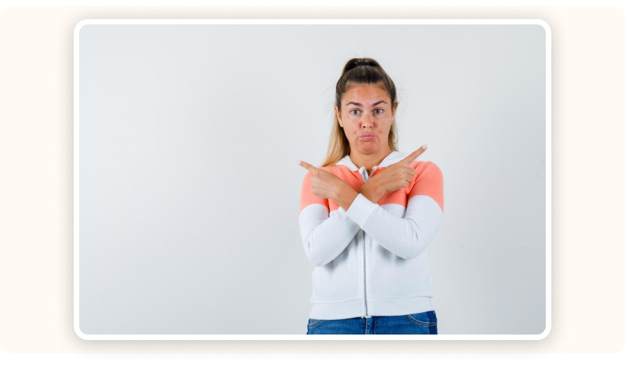 Woman pointing in both directions with a surprised expression.