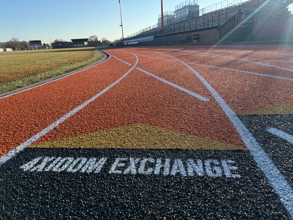 Orange and black track lanes with exchange lettering stenciled in white