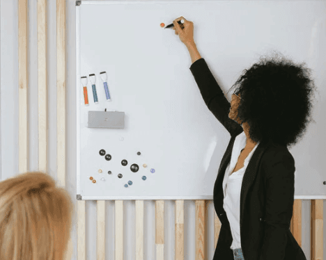 A cozy scene with warm sunlight casting stripes, featuring a potted plant and soft towels on a window sill.