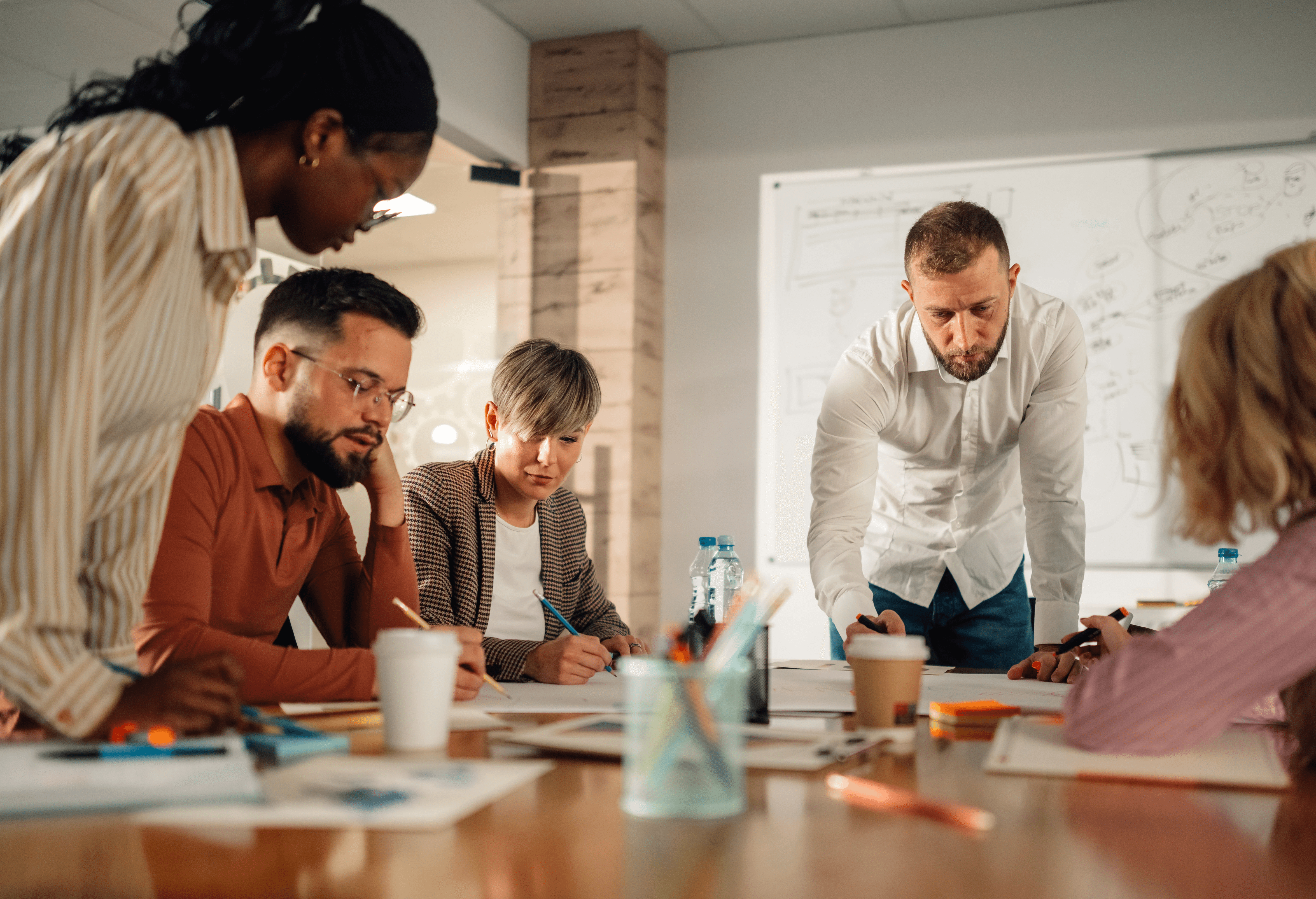 Person smiling while working on a laptop, with icons representing AI-powered research tools around
