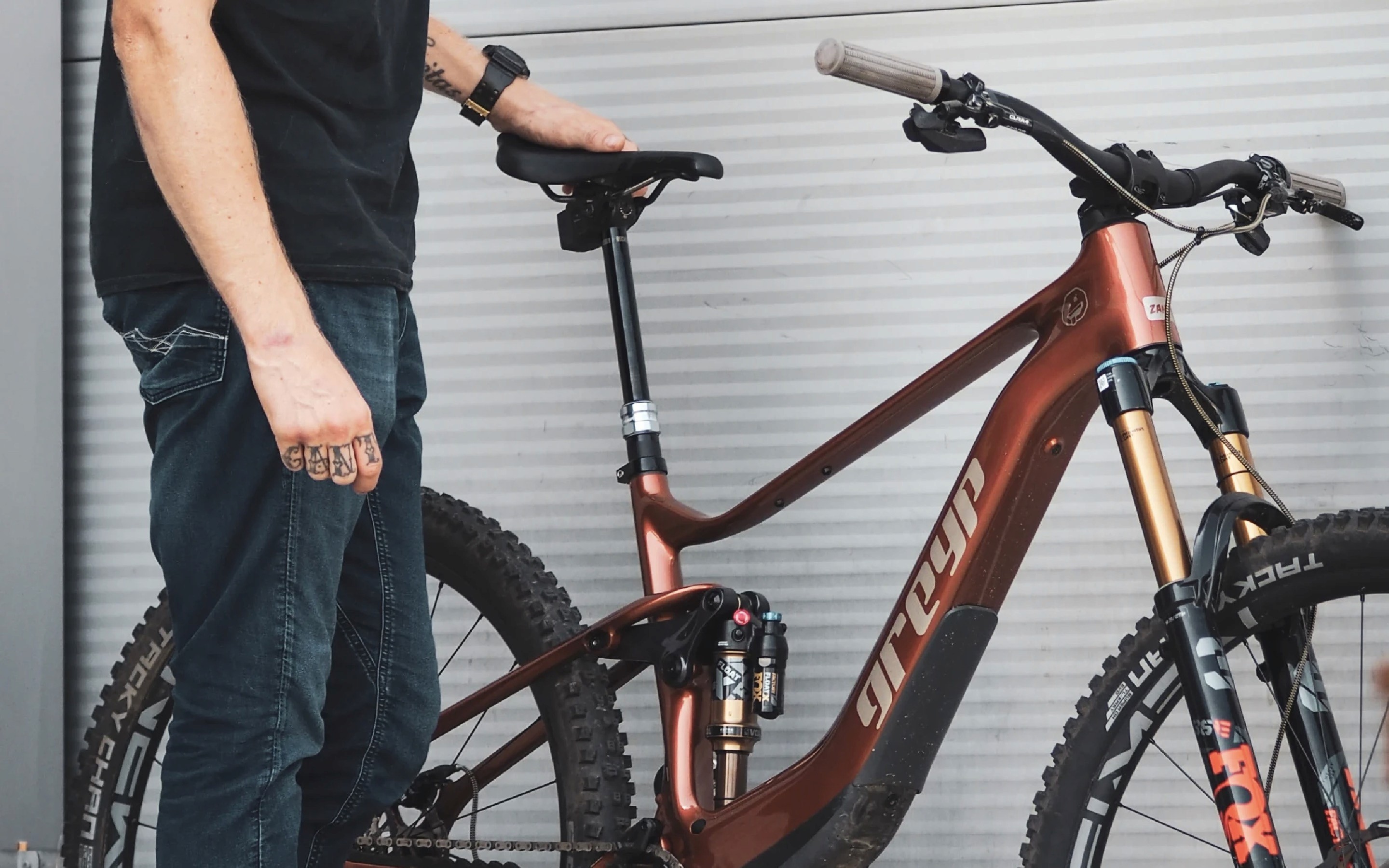 Man standing next to Greyp G4 electric mountain bike.