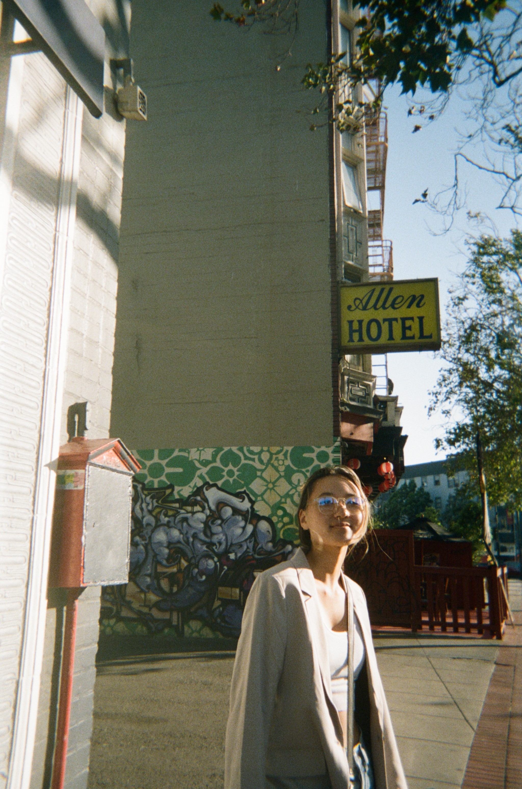 Sarah Kim, a woman in her mid twenties, standing in front of a building