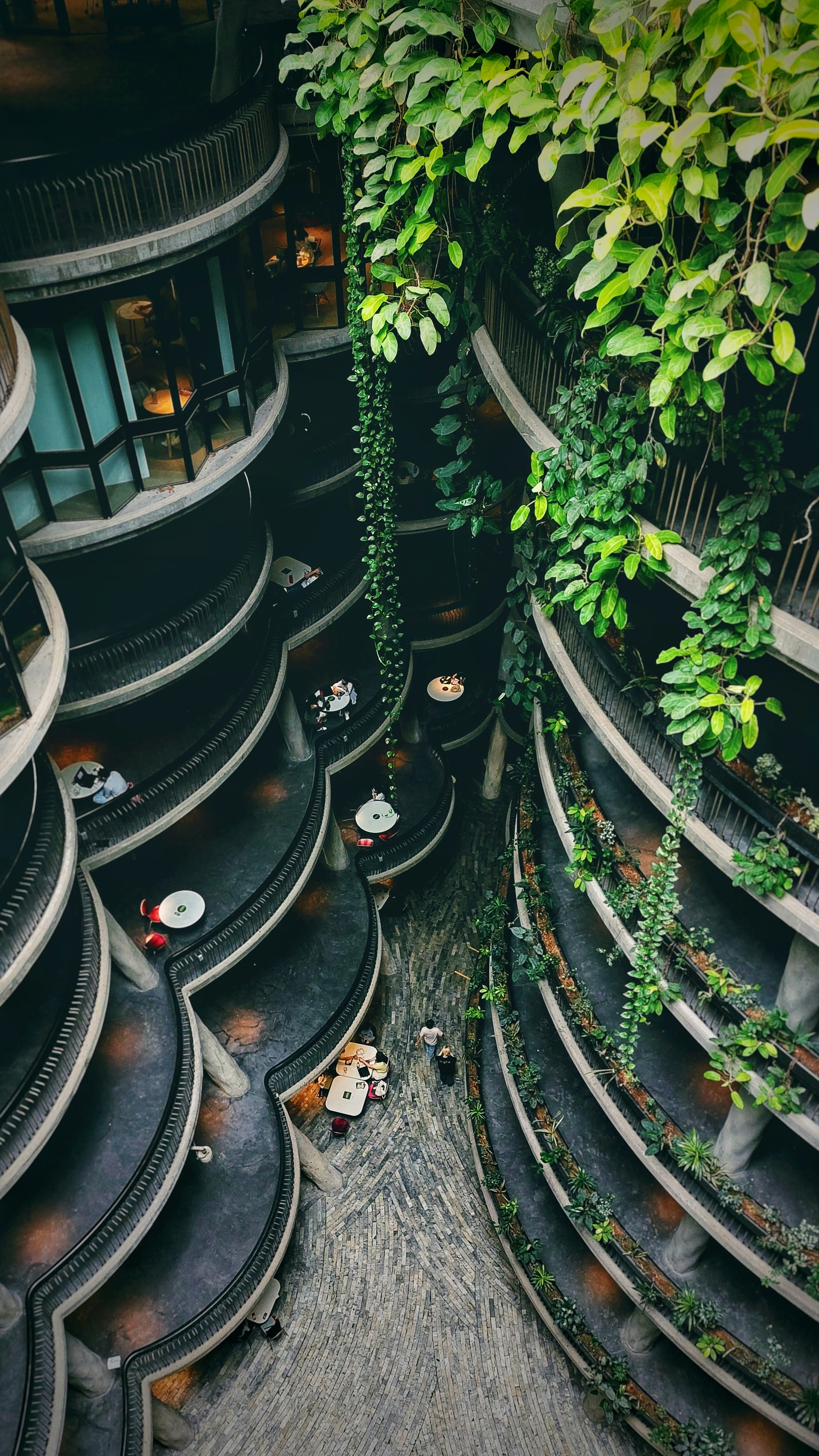 a very tall building with lots of plants growing on it