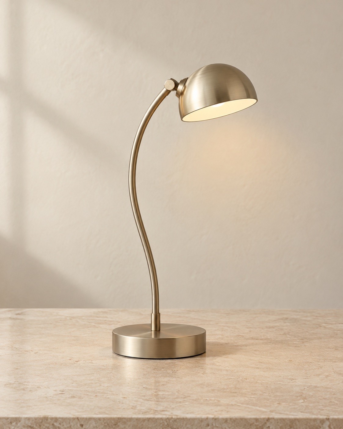 Bend: a warm nickel desk lamp with a curved stem