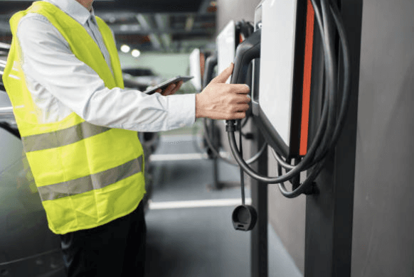 Image of technician doing field service at electric vehicle charging station