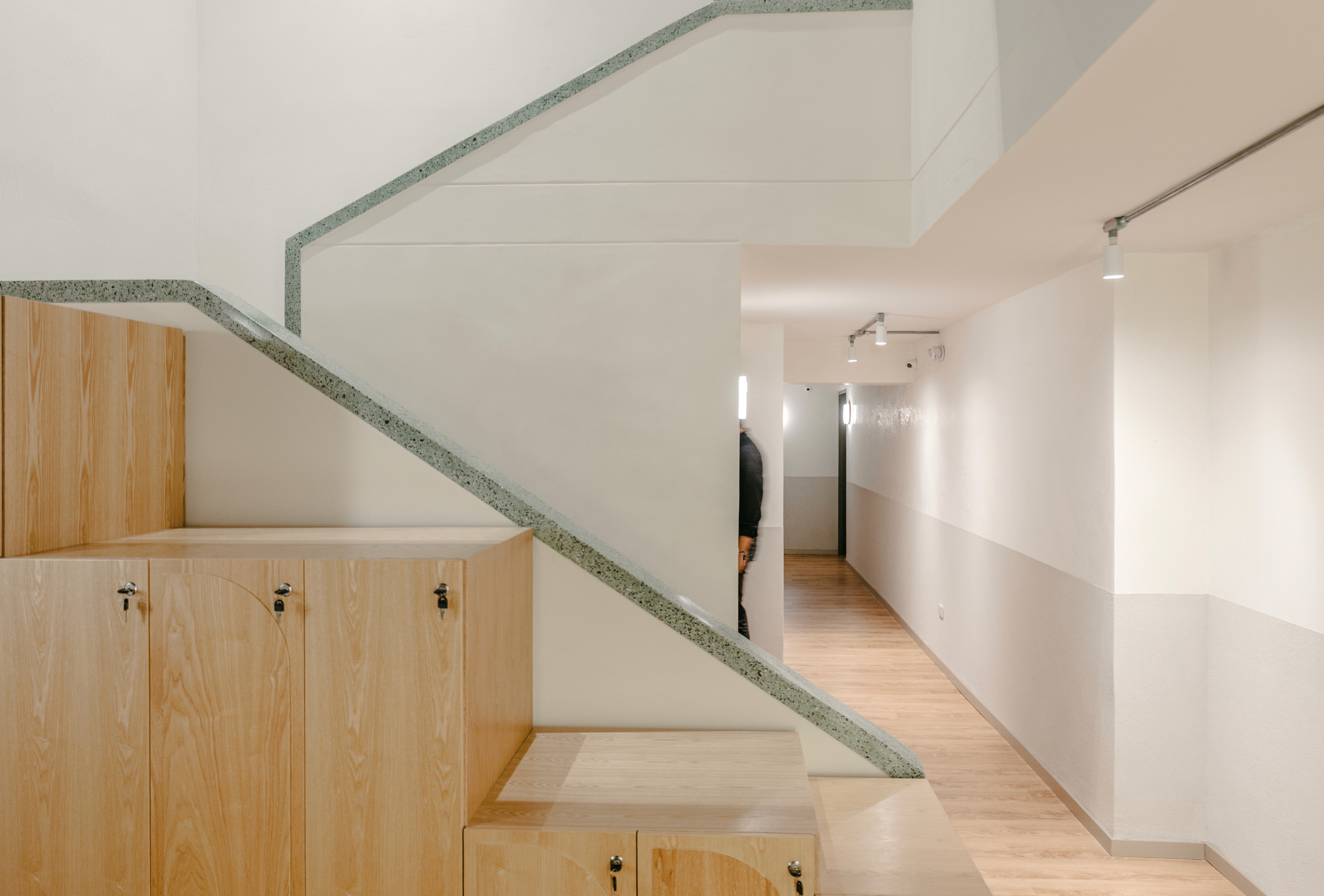 Double-height interior with flowing sculptural forms and warm raking light