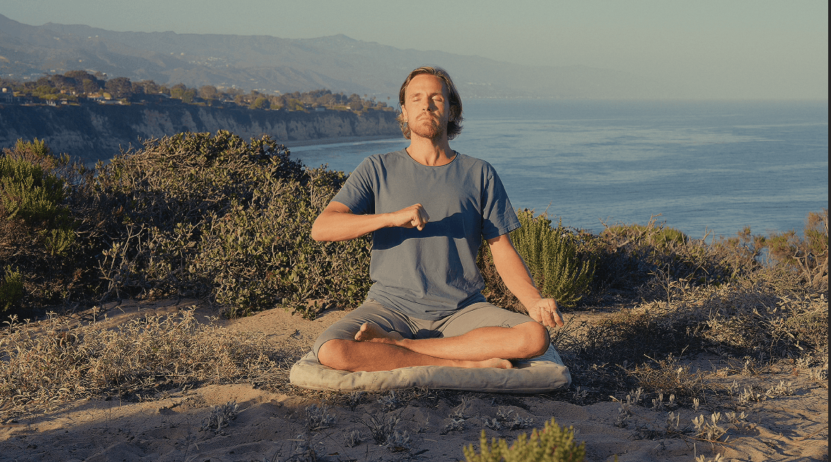 A serene spa setting with two lounge chairs beside a warm, reflective pool and soft, natural lighting.