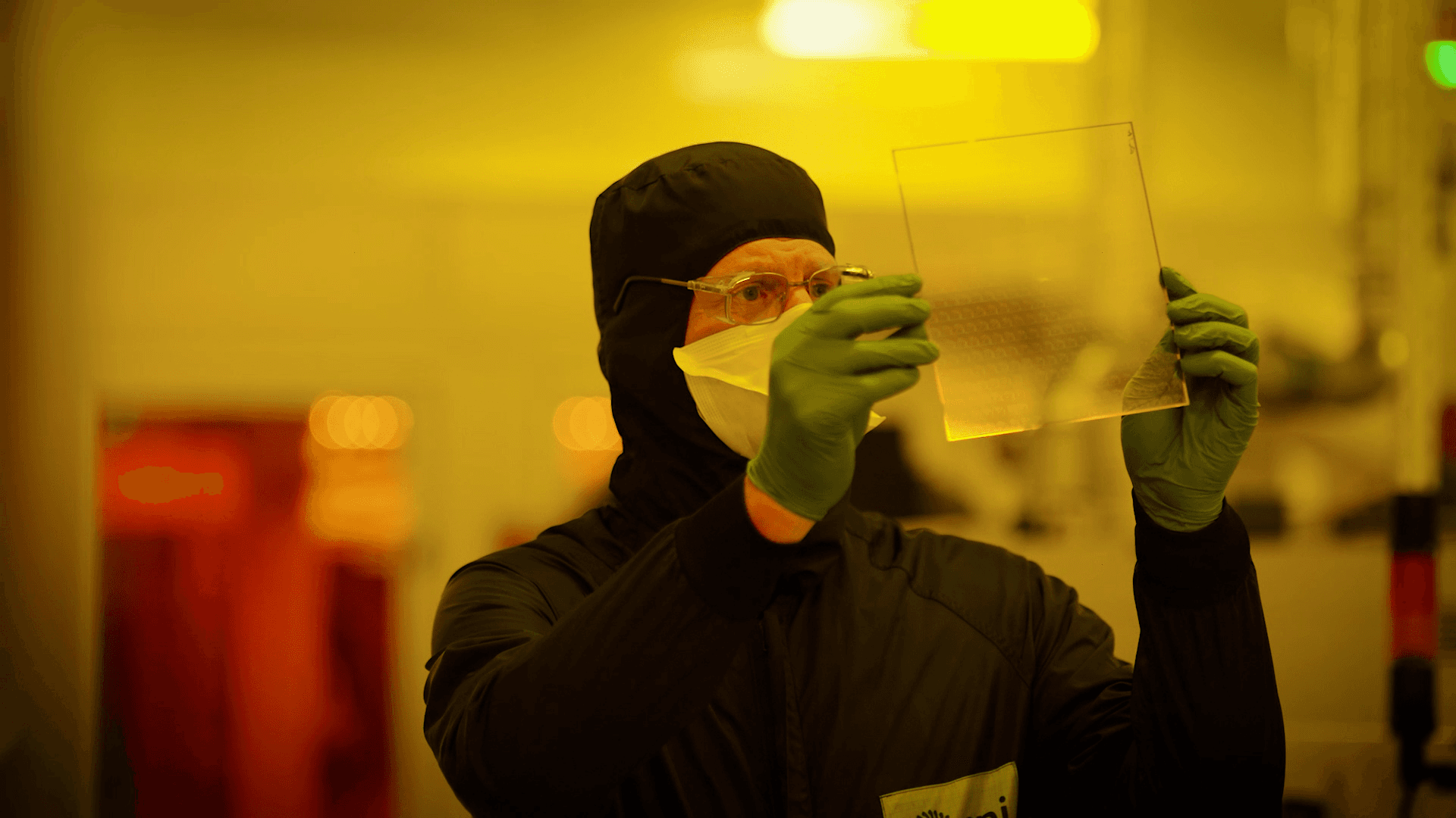 CPI expert inspecting a square peice of plastic.