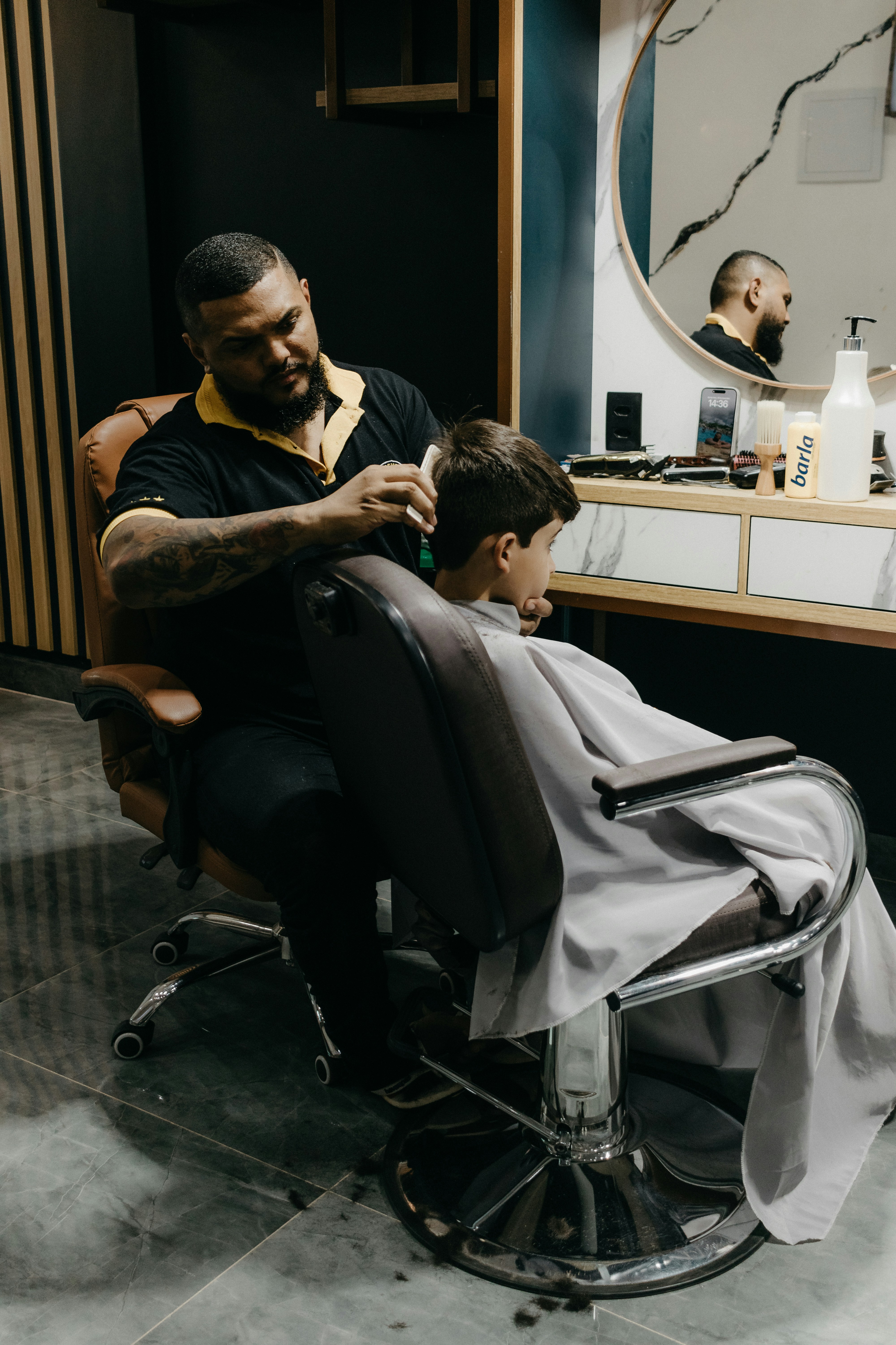 a man getting his hair cut by a barber