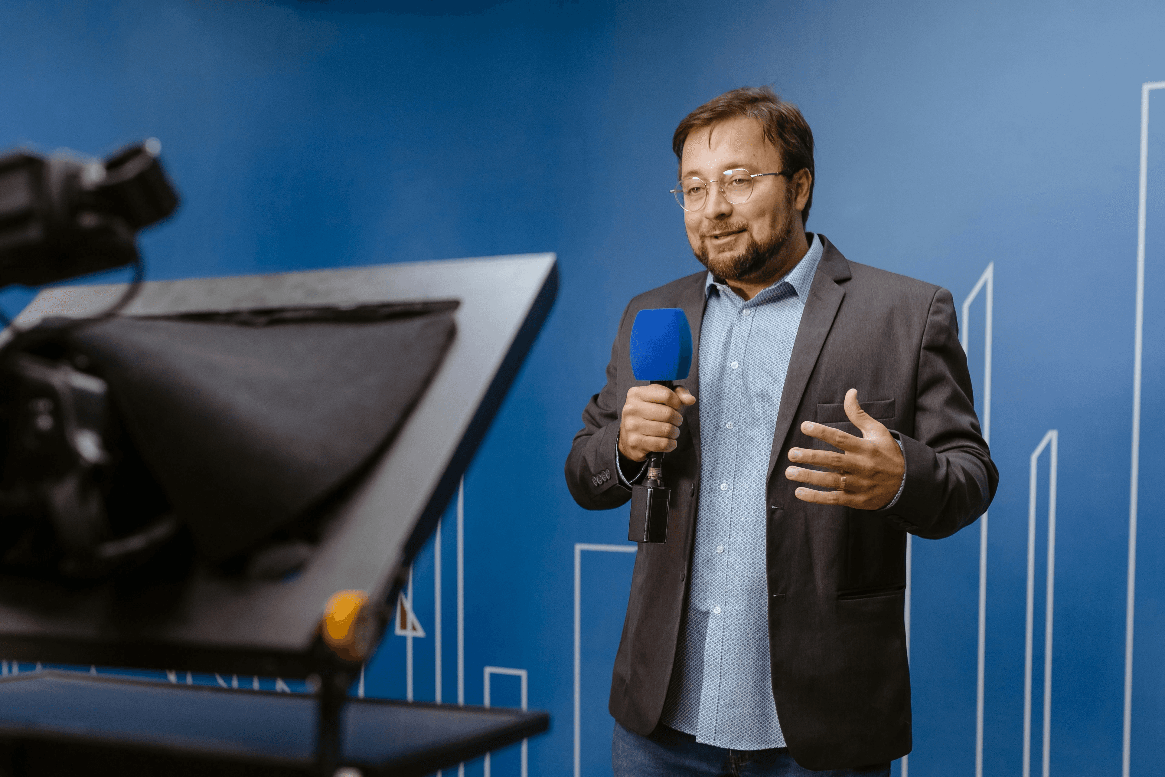 Three professionals in a modern office hallway engaged in a discussion, showcasing a collaborative and professional atmosphere.