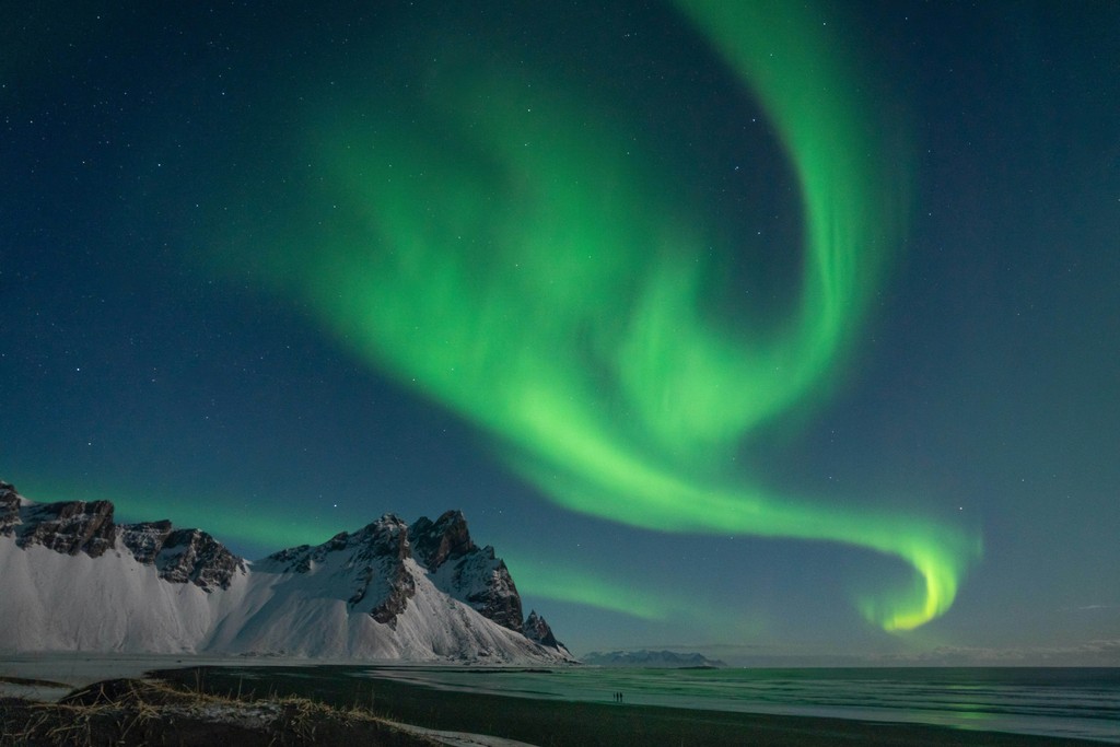 Green aurora lights in the sky at night