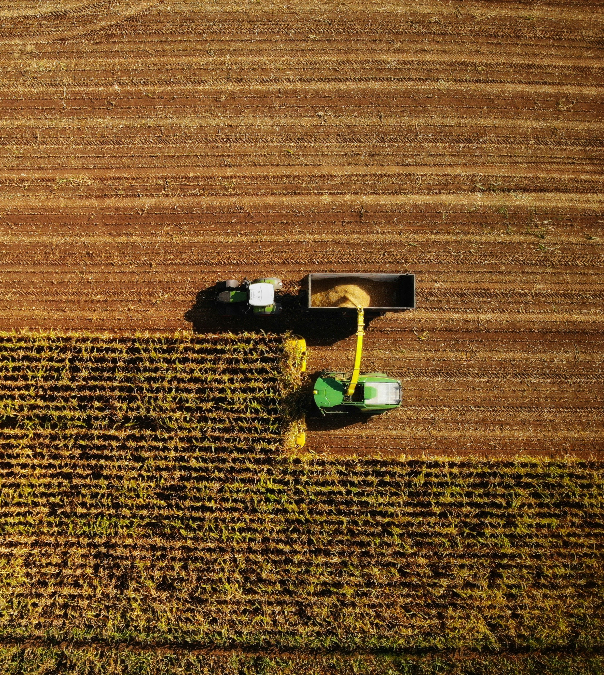 an aerial view of a farmer's tractor in a field